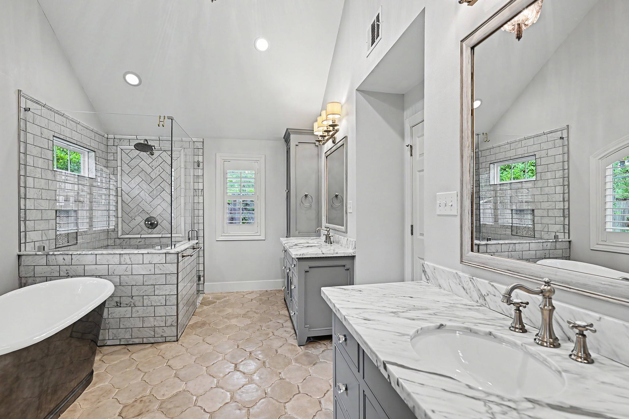 The spa-inspired primary bath features timeless finishes, dual sinks, a large walk-in shower and a relaxing soaking tub.