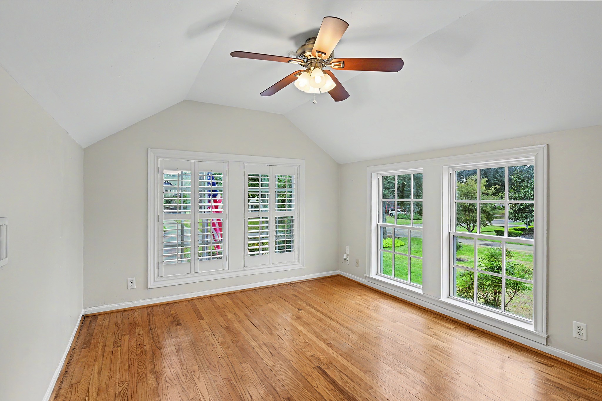 Secondary bedroom on the 2nd floor with large windows overlooking the neighborhood offers a private, flexible space for family, guests or a home office.