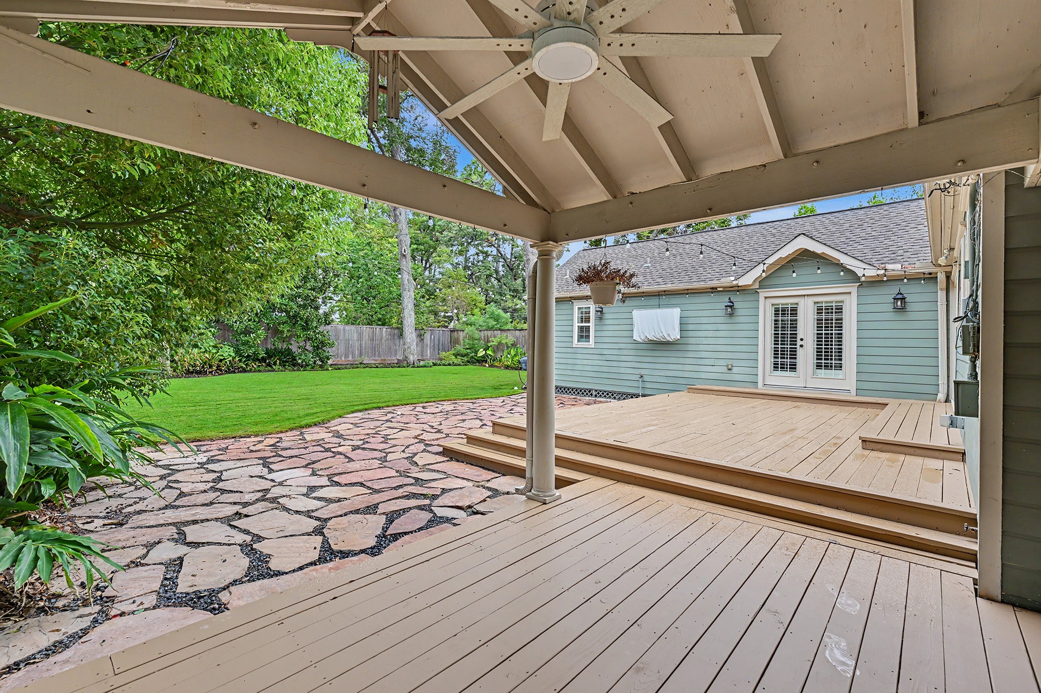 The covered deck provides a shaded outdoor retreat overlooking the private backyard, mature trees and nice landscaping.
