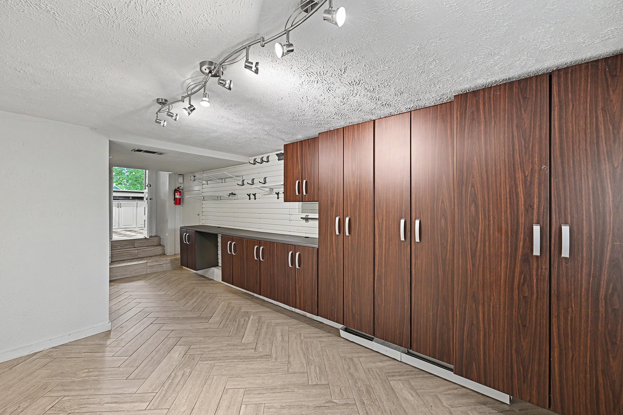 The versatile bonus room off the kitchen can serve as a den, home office, playroom, workshop or additional bedroom, with exceptional built-in storage throughout the space.