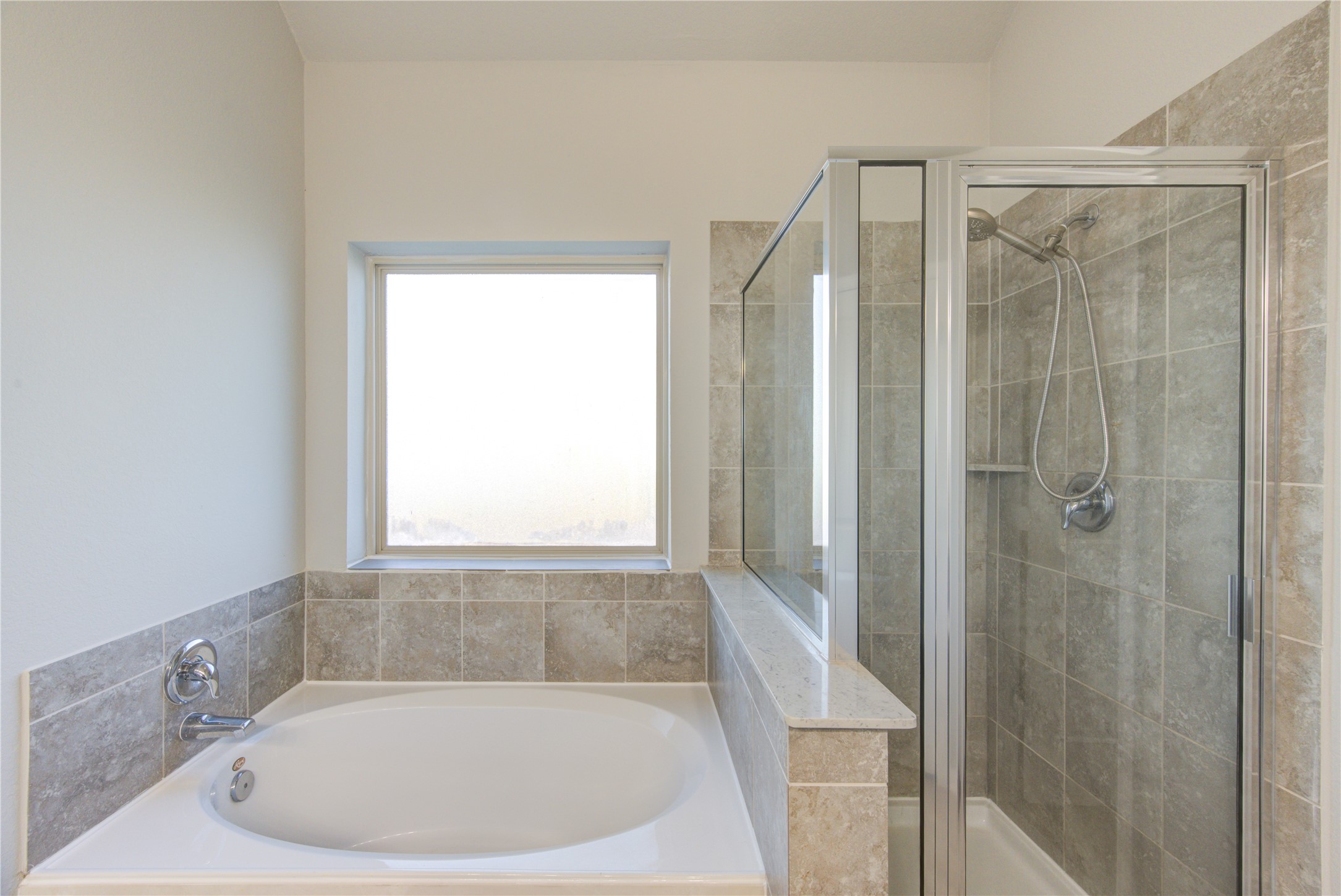 Spacious walk-in closet with multiple wooden hanging rods and light-colored walls, providing ample storage space.