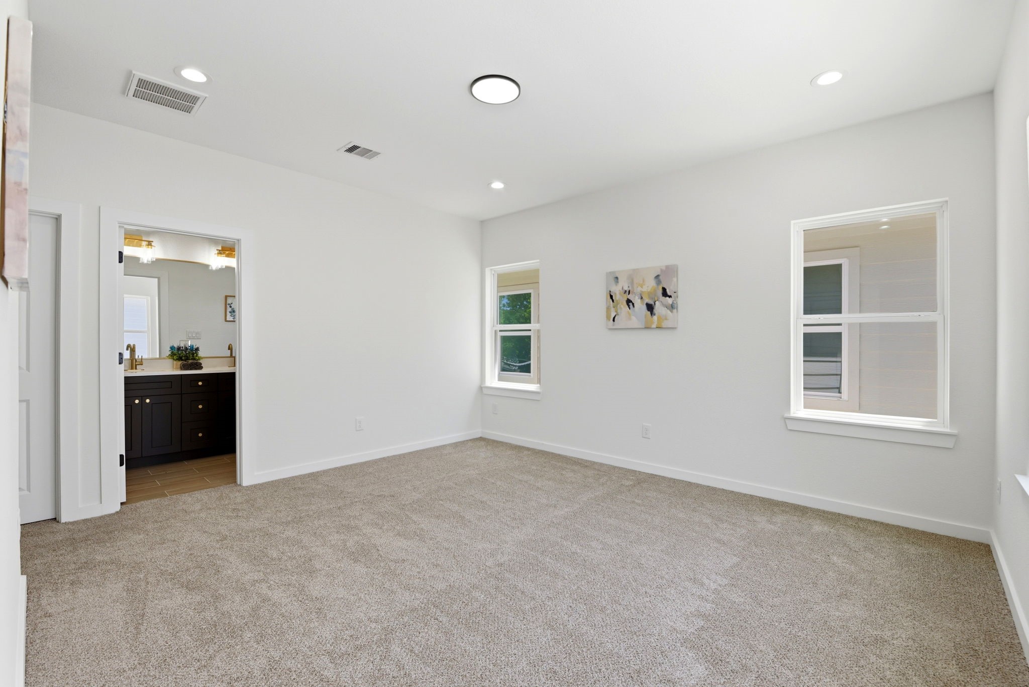 Primary bedroom, includes an en-suite bathroom with modern fixtures.