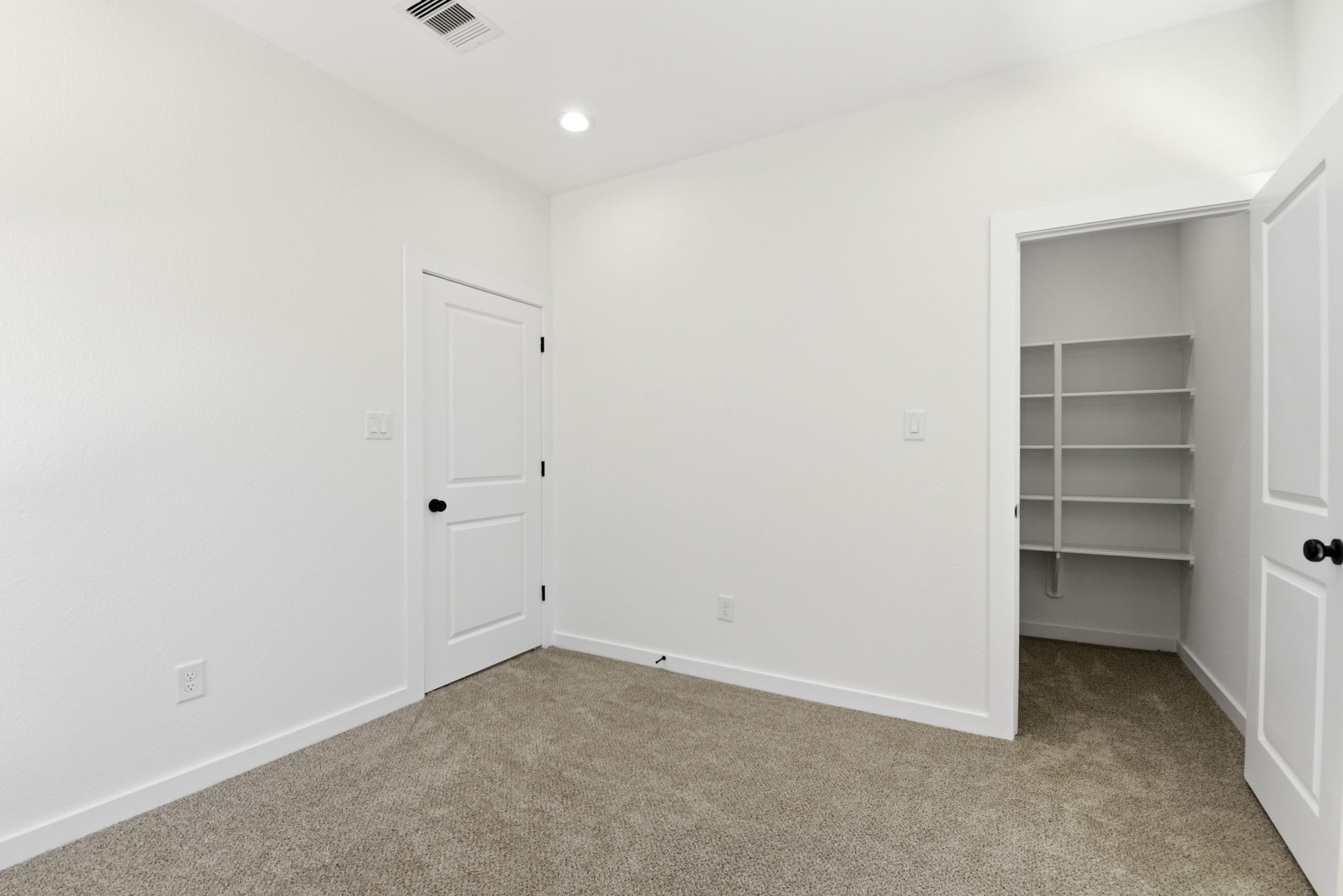 Secondary bedroom with walk in closet