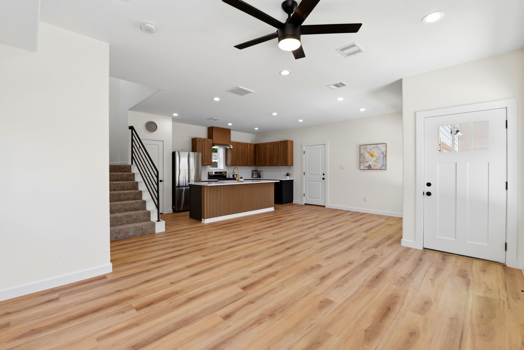Modern open-concept living space with lots of natural light and recessed lighting.