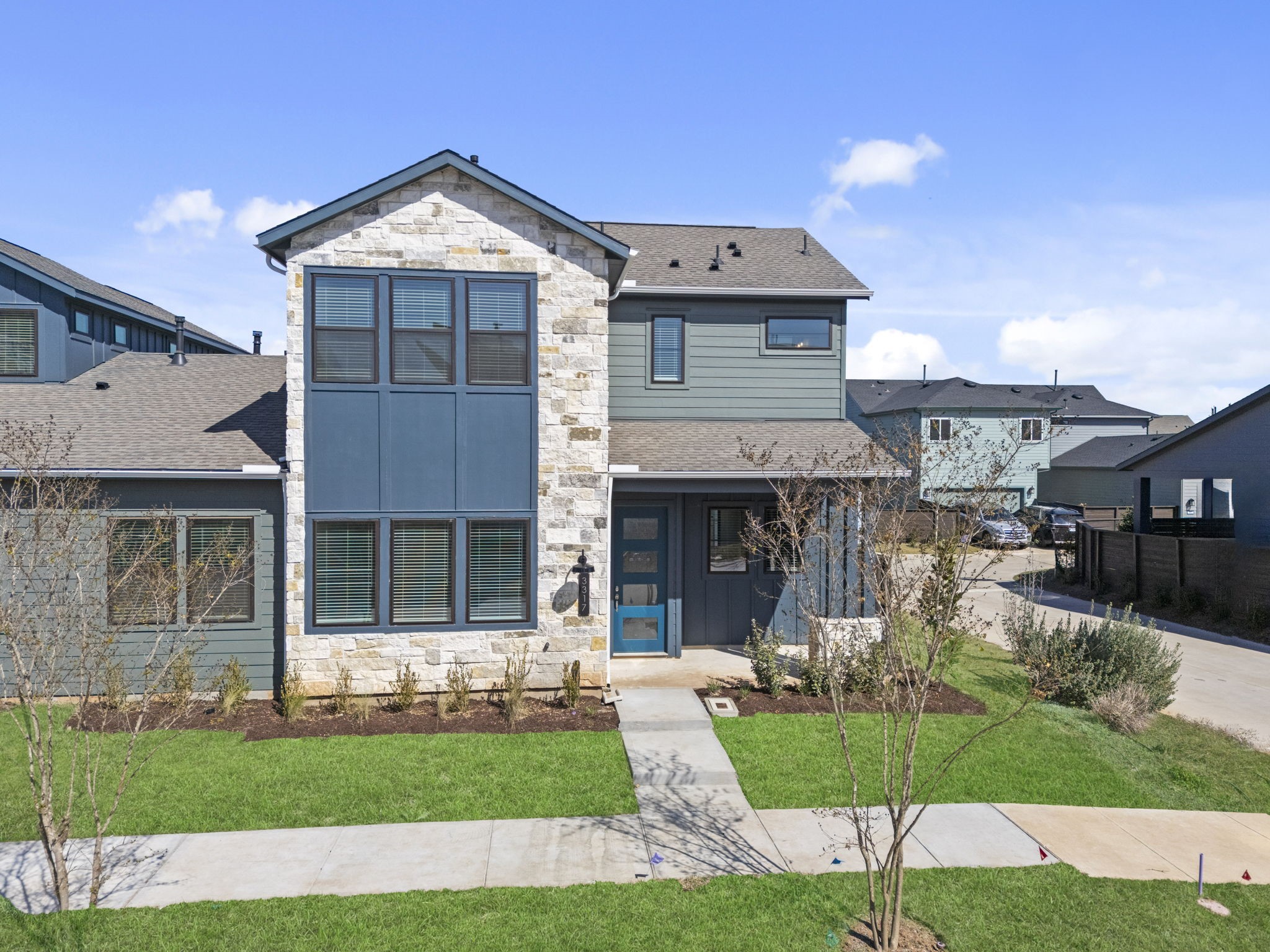 The stunning exterior makes a lasting first impression, blending modern design with beautiful landscaping, clean lines, and warm architectural details.