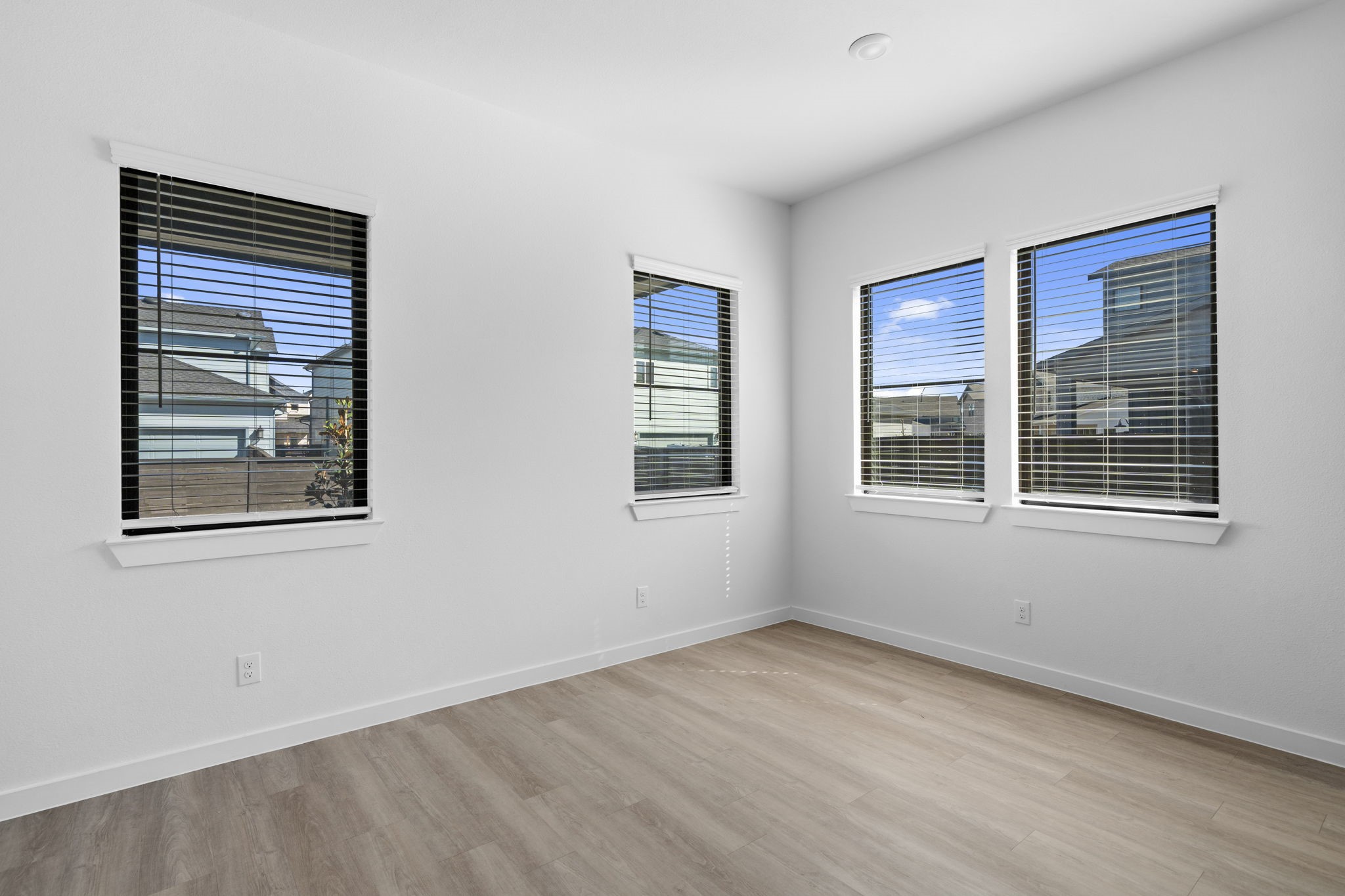 Just off the kitchen, the designated dining area creates a bright and welcoming space for shared meals and everyday moments. Large windows fill the room with natural light, while the direct access to the covered patio makes it easy to take the gathering outdoors.