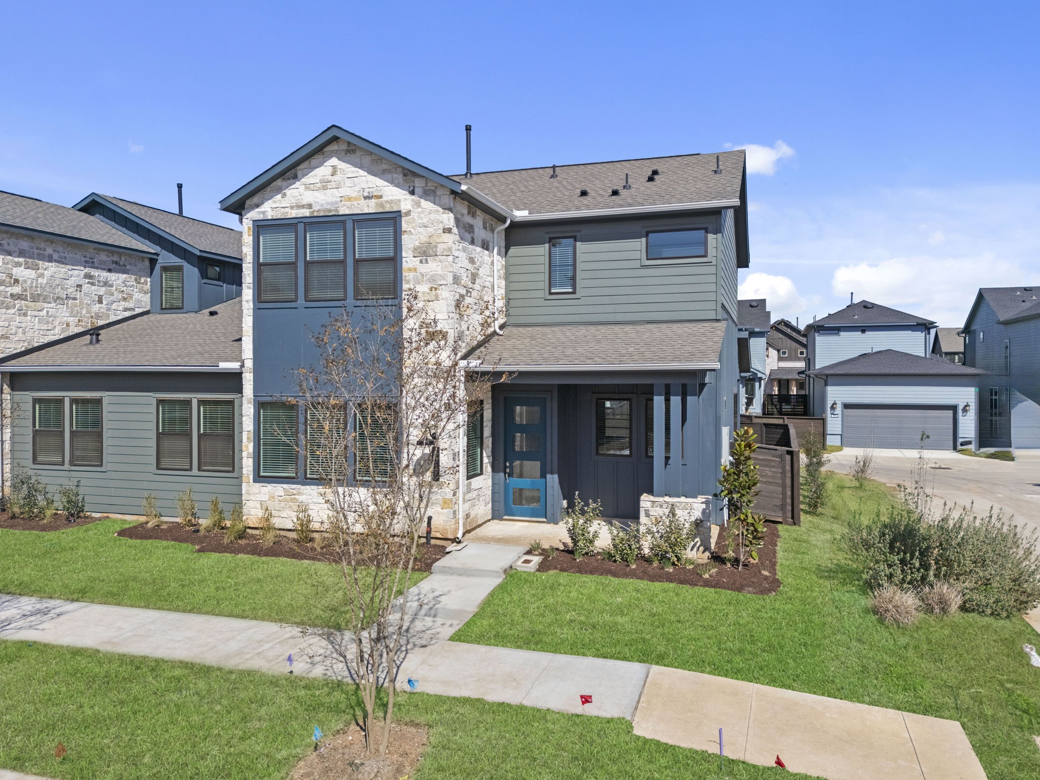 Feel proud to call this modern home yours, nestled in the thoughtfully designed Indigo master-planned community. With its inviting curb appeal, beautifully landscaped yard, and distinctive stone and siding exterior, this home welcomes you with a fresh, stylish feel from the moment you arrive.