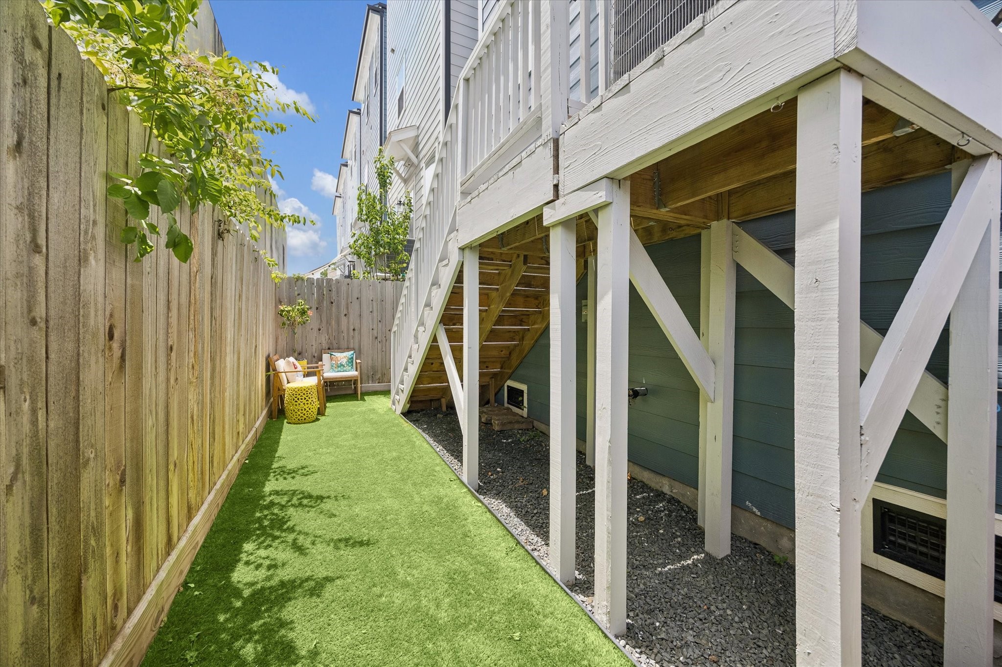The fenced yard offers a practical extension of the home with artificial turf, deck access, and just enough space to enjoy the outdoors with ease.