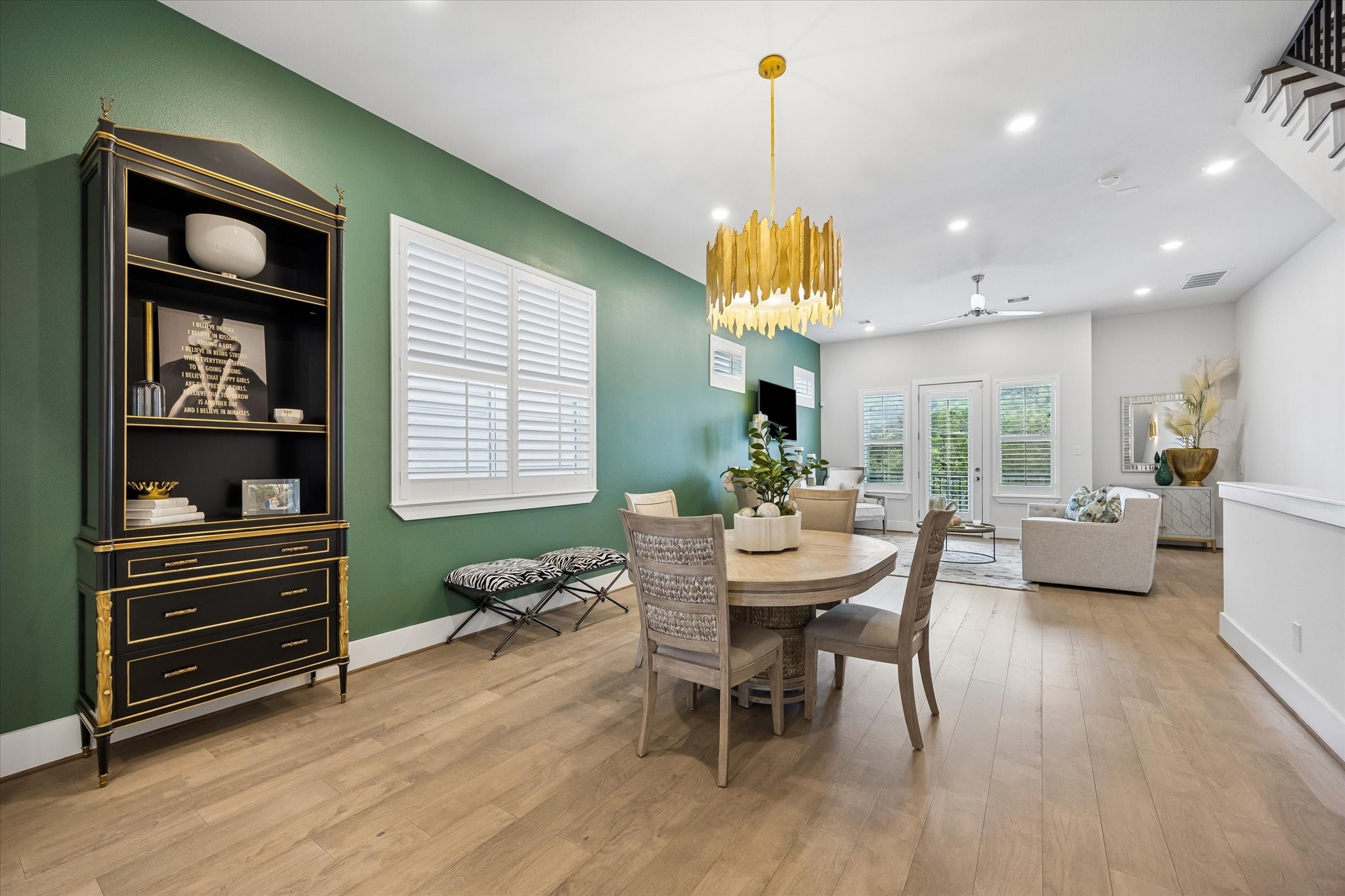 The open main floor layout makes everyday living feel effortless, with the dining area connecting naturally to the living room, balcony access, and island kitchen.