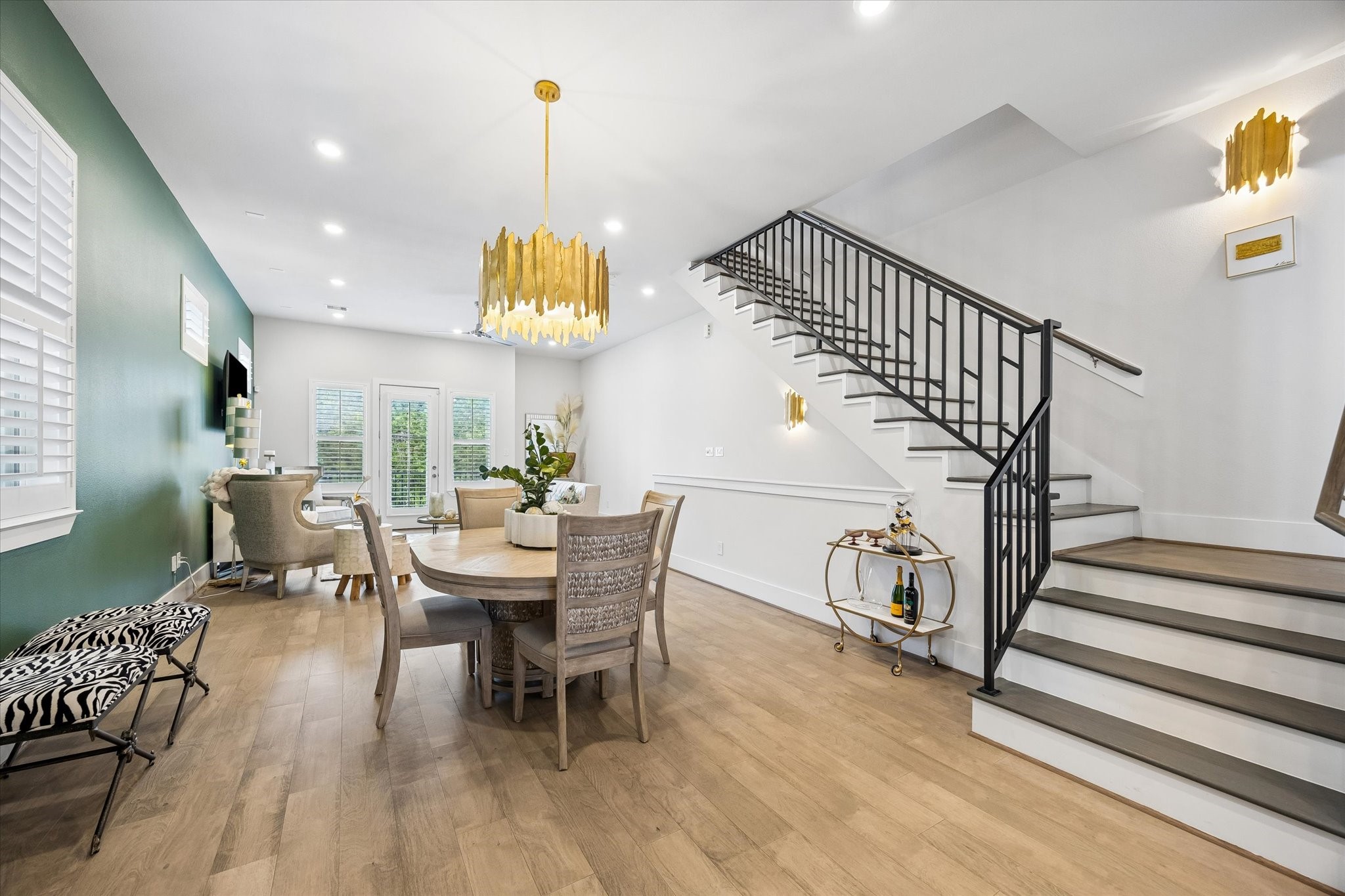 Whether you are hosting a lavish dinner party or enjoying a quiet night in, the dining area sits at the heart of the main floor with beautiful lighting, warm engineered wood flooring, and plenty of room to gather.