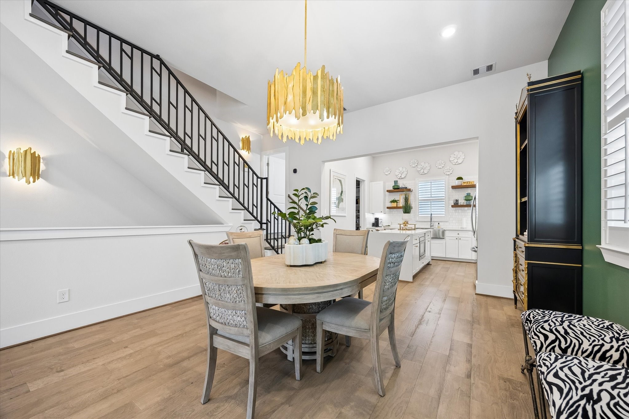 Gather them around your table to honor old traditions and create the new. This elegant dining area feels polished and inviting, with 10' ceilings, a statement chandelier, and a seamless flow into the kitchen and living area.
