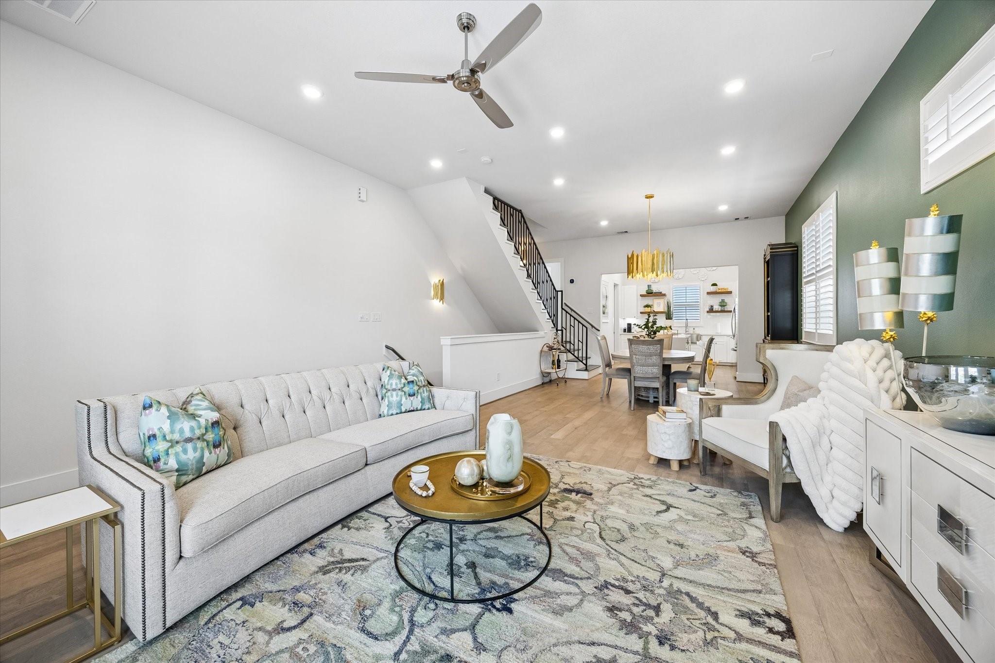 This open living area offers plenty of room to relax, gather, and entertain, with an easy flow into the dining area and island kitchen for everyday living that feels both connected and comfortable.