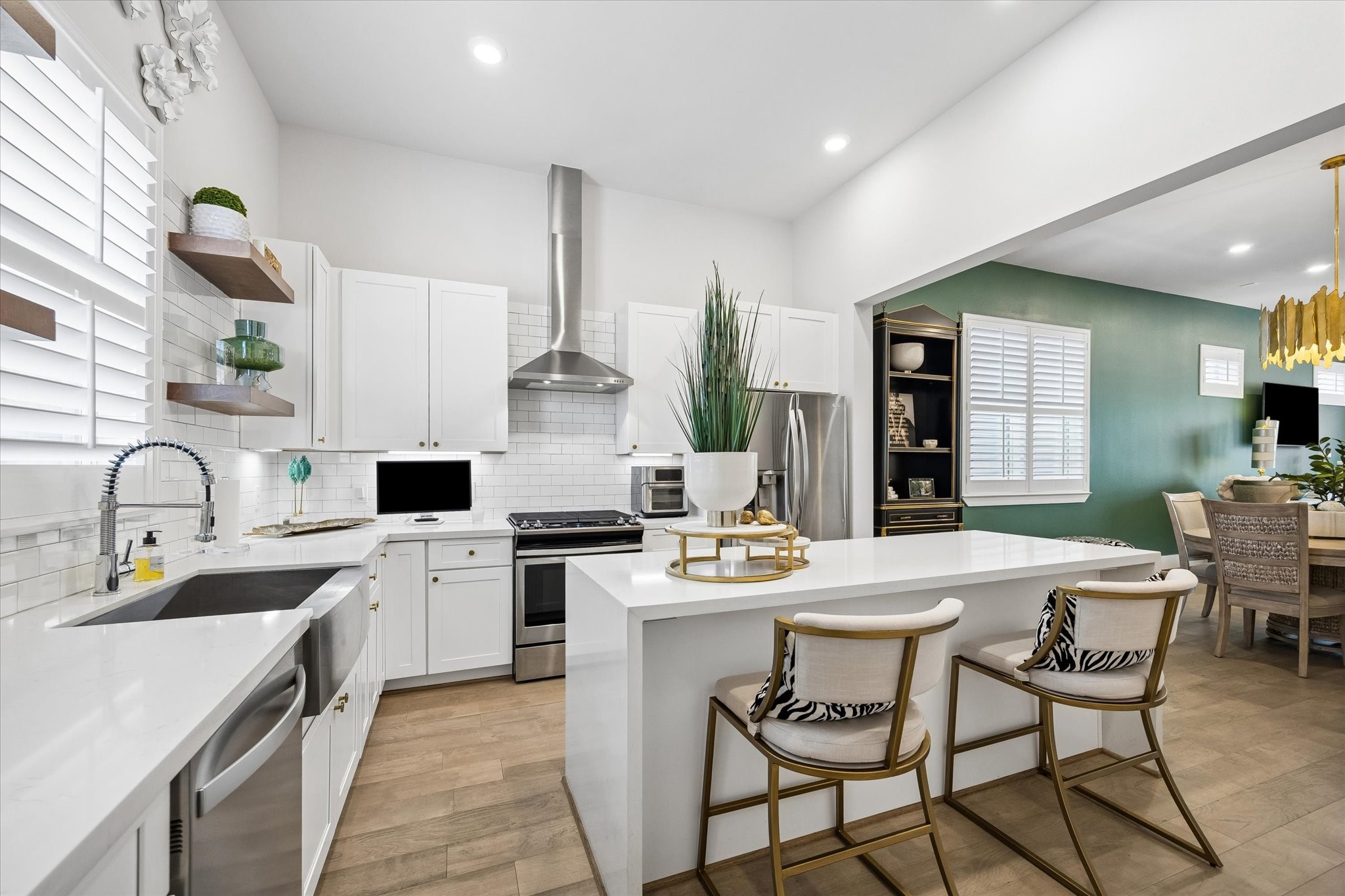 Show off your culinary skills in this fully loaded kitchen, where every detail feels high-end, highly functional, and 100% full of style, from the quartz countertops and waterfall island to the upgraded farmhouse apron front sink, sleek hood vent, and stainless-steel appliances.