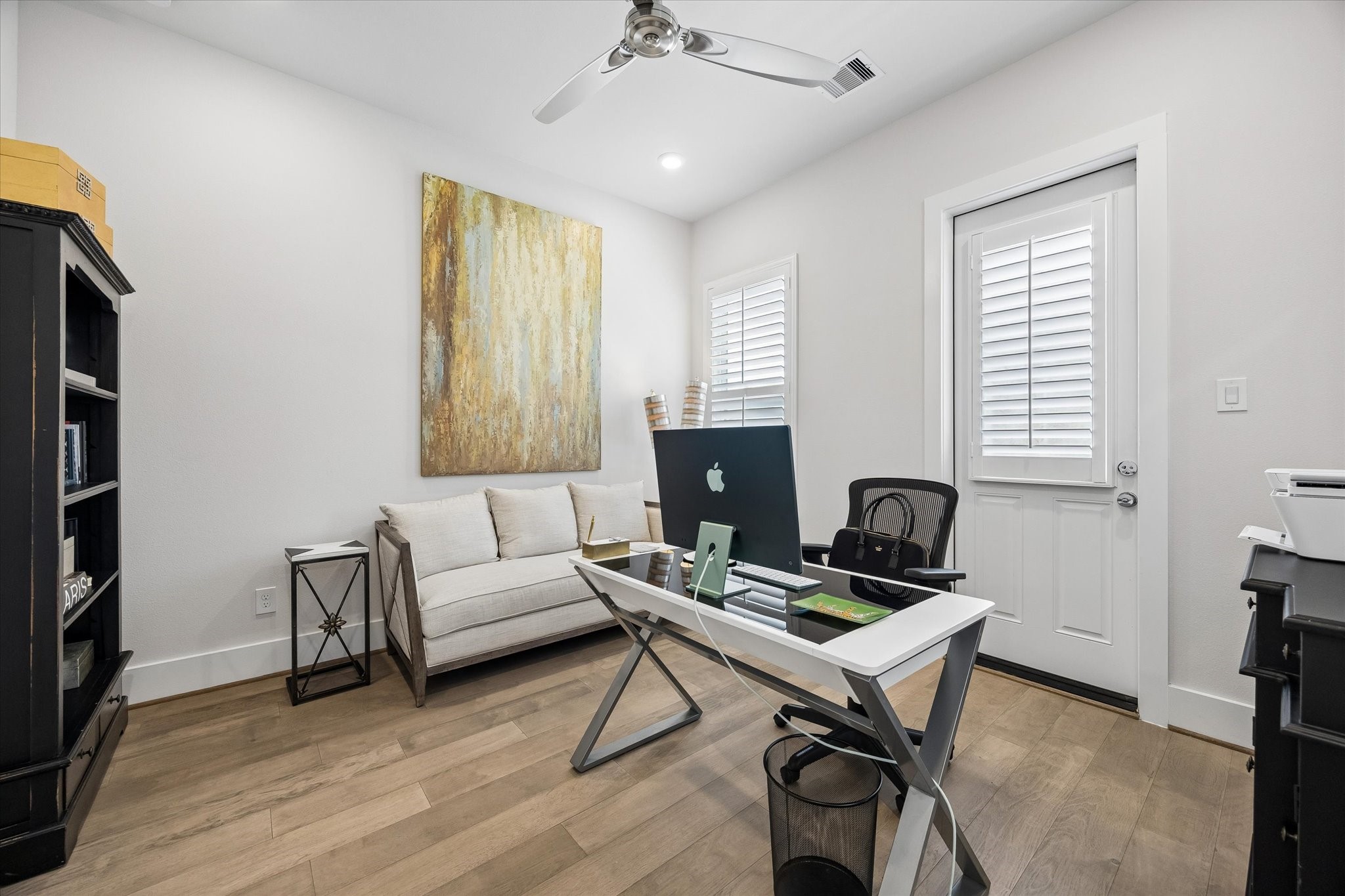 You will love the privacy and flexibility of this first-floor suite, complete with engineered wood flooring, wood shuttered windows, a walk-in closet, an ensuite bath, and direct access to the back deck and small fenced area. Tucked away from the rest of the home, this space would also make a great home office, creative studio, workout room, or quiet retreat.