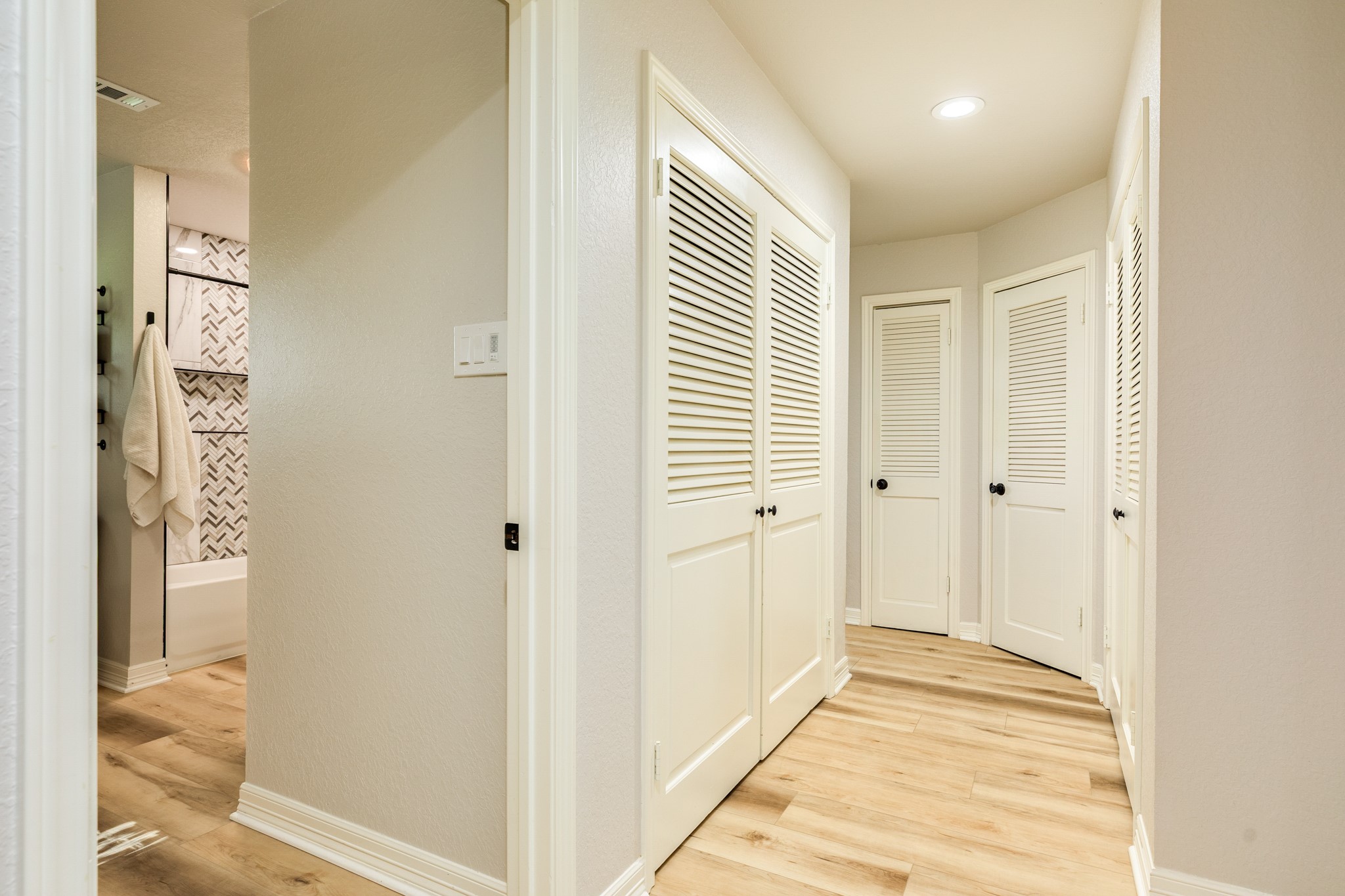 Hallway leading to the secondary bedrooms, highlighting the homes split floor plan and abundant storage