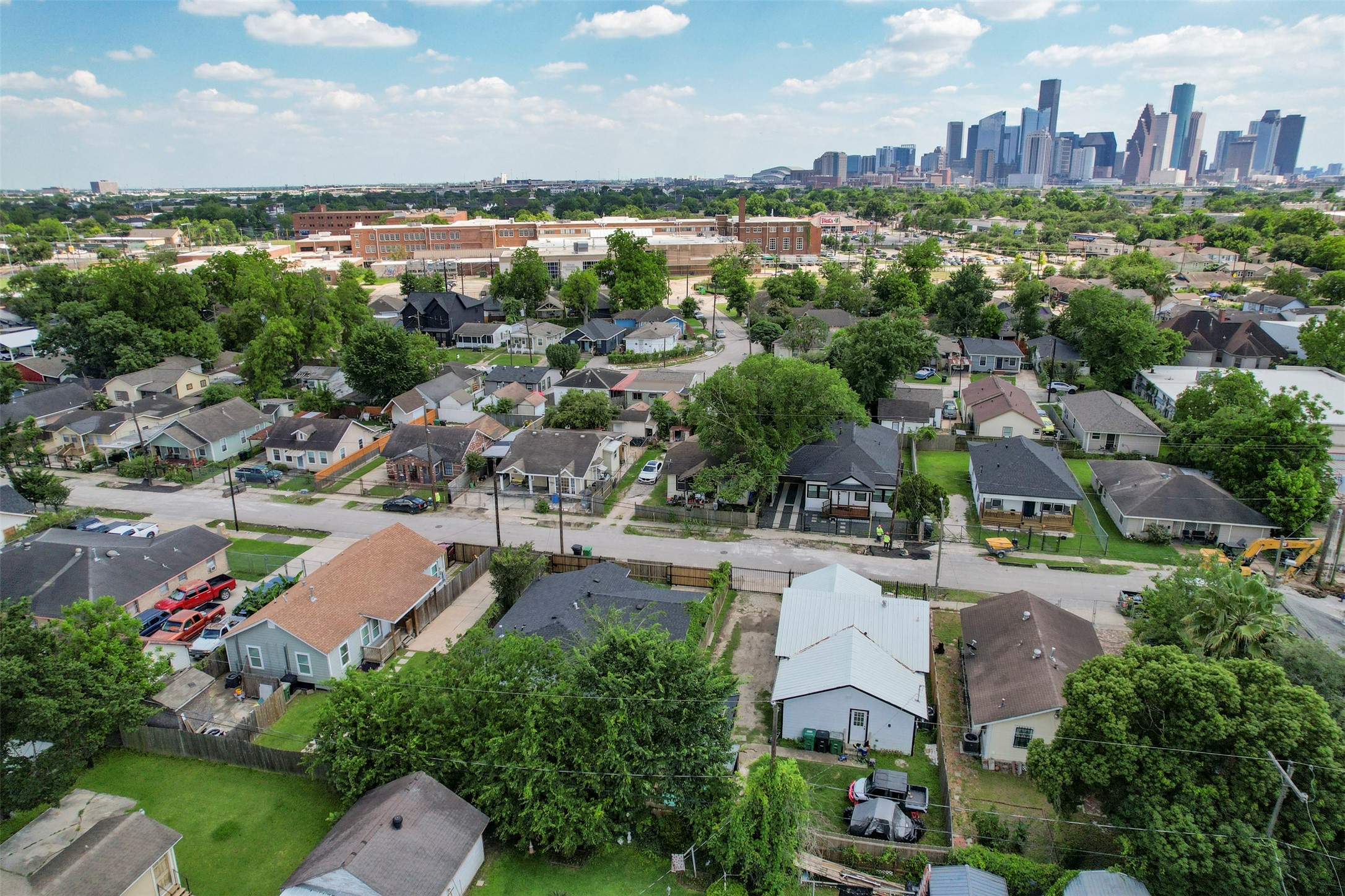 Aerial view showcasing the Near Northside neighborhood with the full Downtown Houston skyline visible, highlighting active new construction and reinvestment happening throughout the corridor.