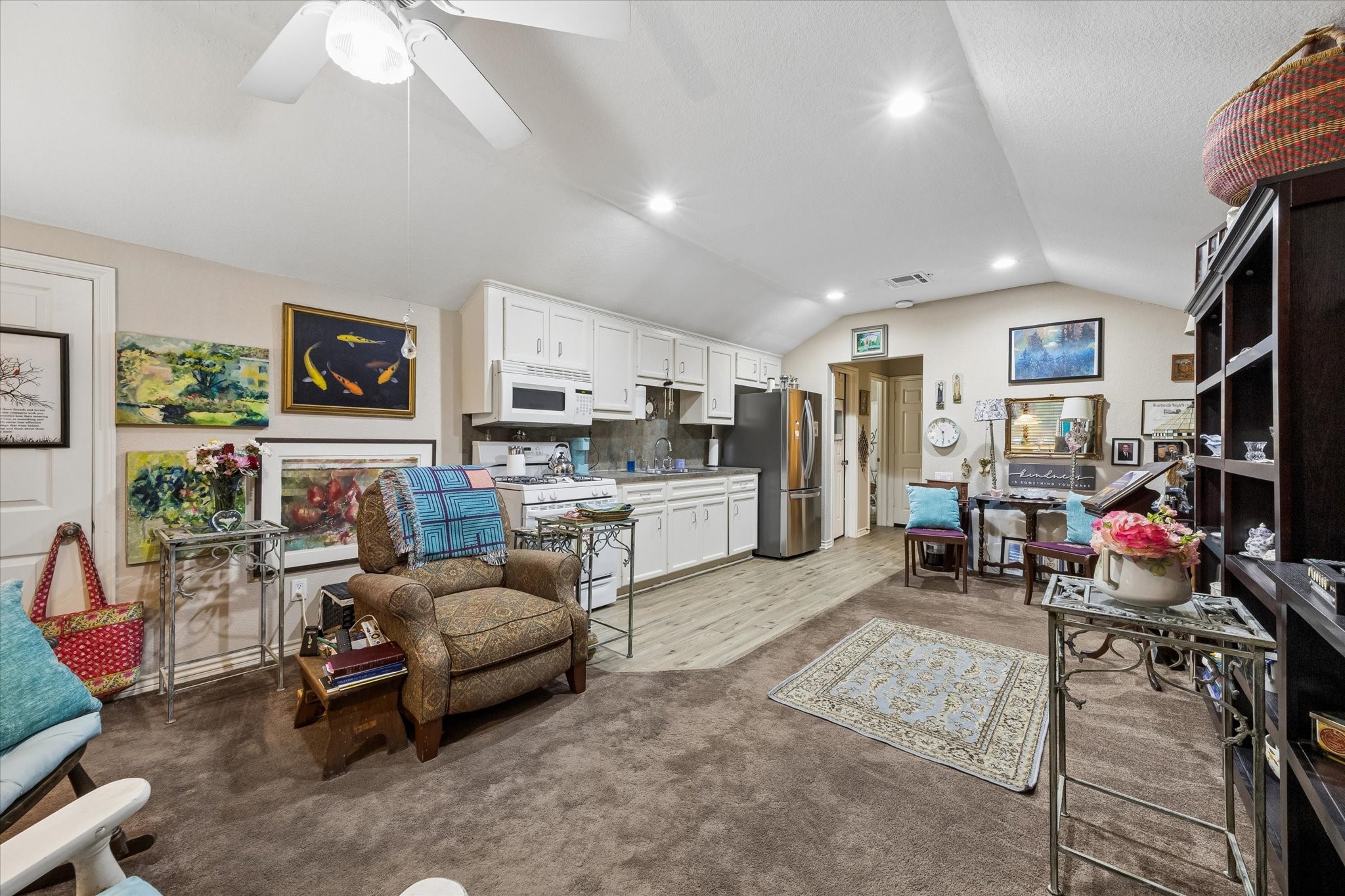 Private upstairs garage apartment featuring a full kitchen, living area, and vaulted ceiling. Ideal for guests, extended living, or potential rental income with a self-contained layout.
