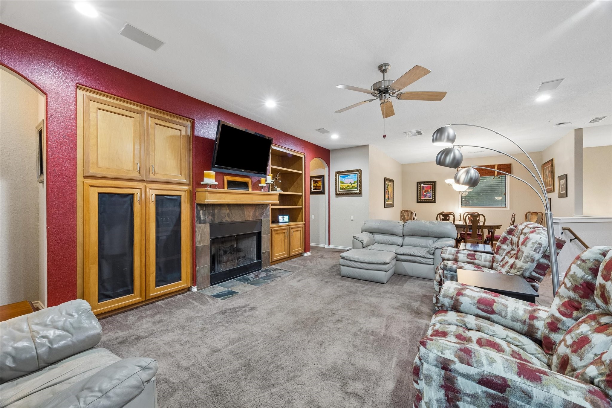 Open-concept living area with built-in cabinetry, fireplace, and media center. Spacious layout flows into the dining area, offering flexible seating and comfortable everyday living. Open-concept living area with built-in cabinetry, fireplace, and media center. Spacious layout flows into the dining area, offering flexible seating and comfortable everyday living.