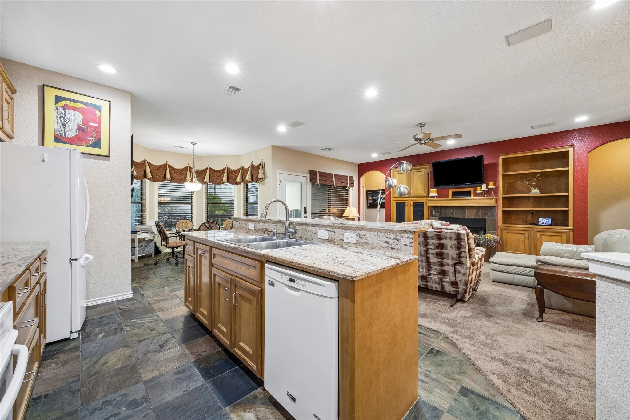 Spacious kitchen with large center island, double sink, and extensive cabinetry for storage. Open to the living area with adjacent breakfast space, providing functional flow for daily use and entertaining. Spacious kitchen with large center island, double sink, and extensive cabinetry for storage. Open to the living area with adjacent breakfast space, providing functional flow for daily use and entertaining.