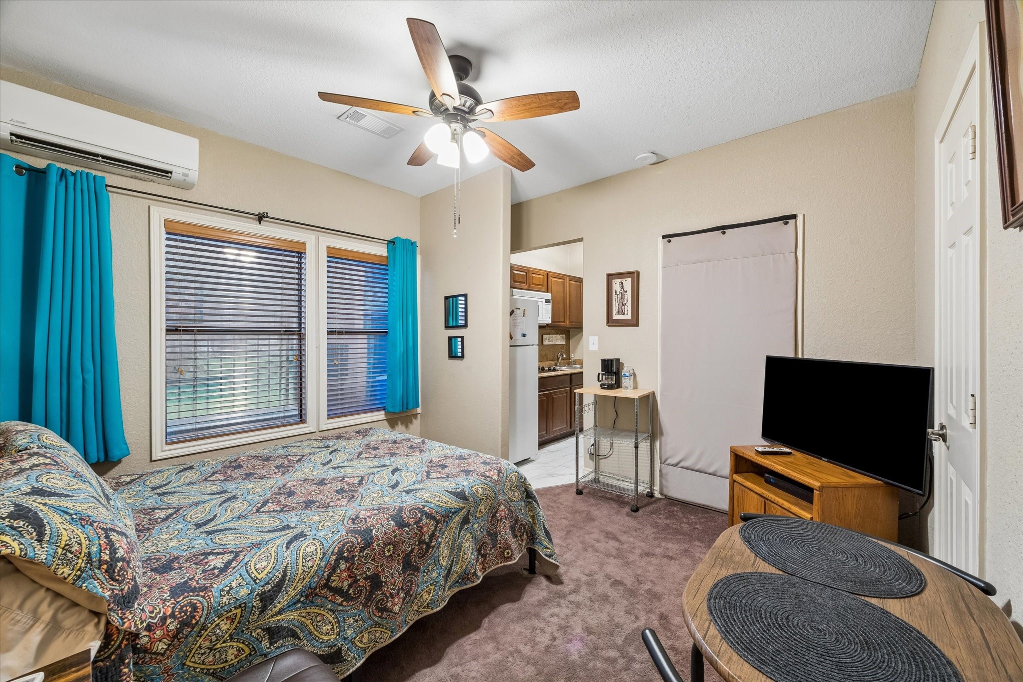 Fourth bedroom configured as a private suite, featuring a kitchenette, en-suite bathroom, and separate exterior entry. Currently utilized as a short-term rental, offering strong flexibility for guest accommodations or income-producing use.