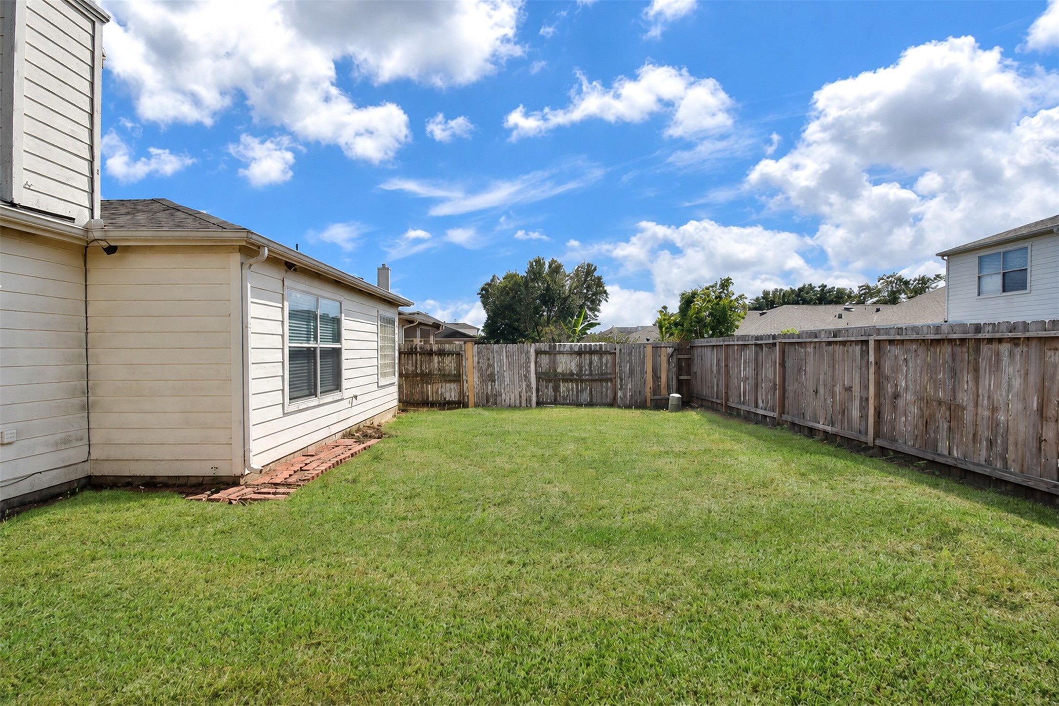 Backyard
***Property is vacant. Photo digitally enhanced with AI; lighting, color, and ceiling appearance adjusted. ***