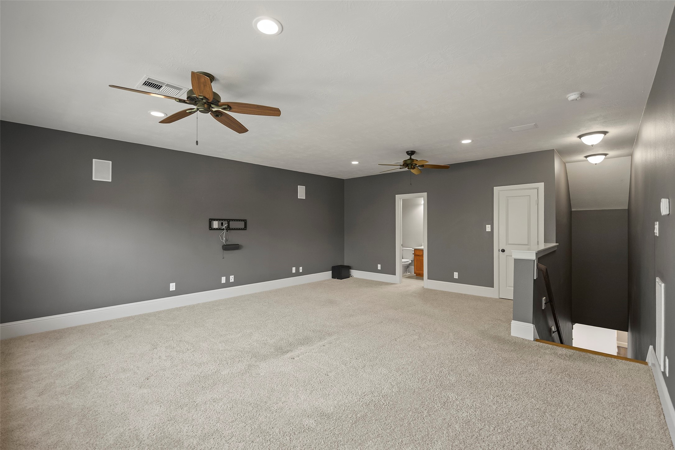 Flexible upstairs game/media room with a full bathroom and large closet.