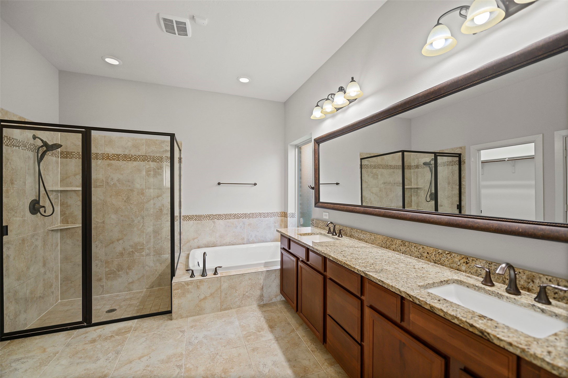Primary bathroom with garden tub and separate oversized shower.