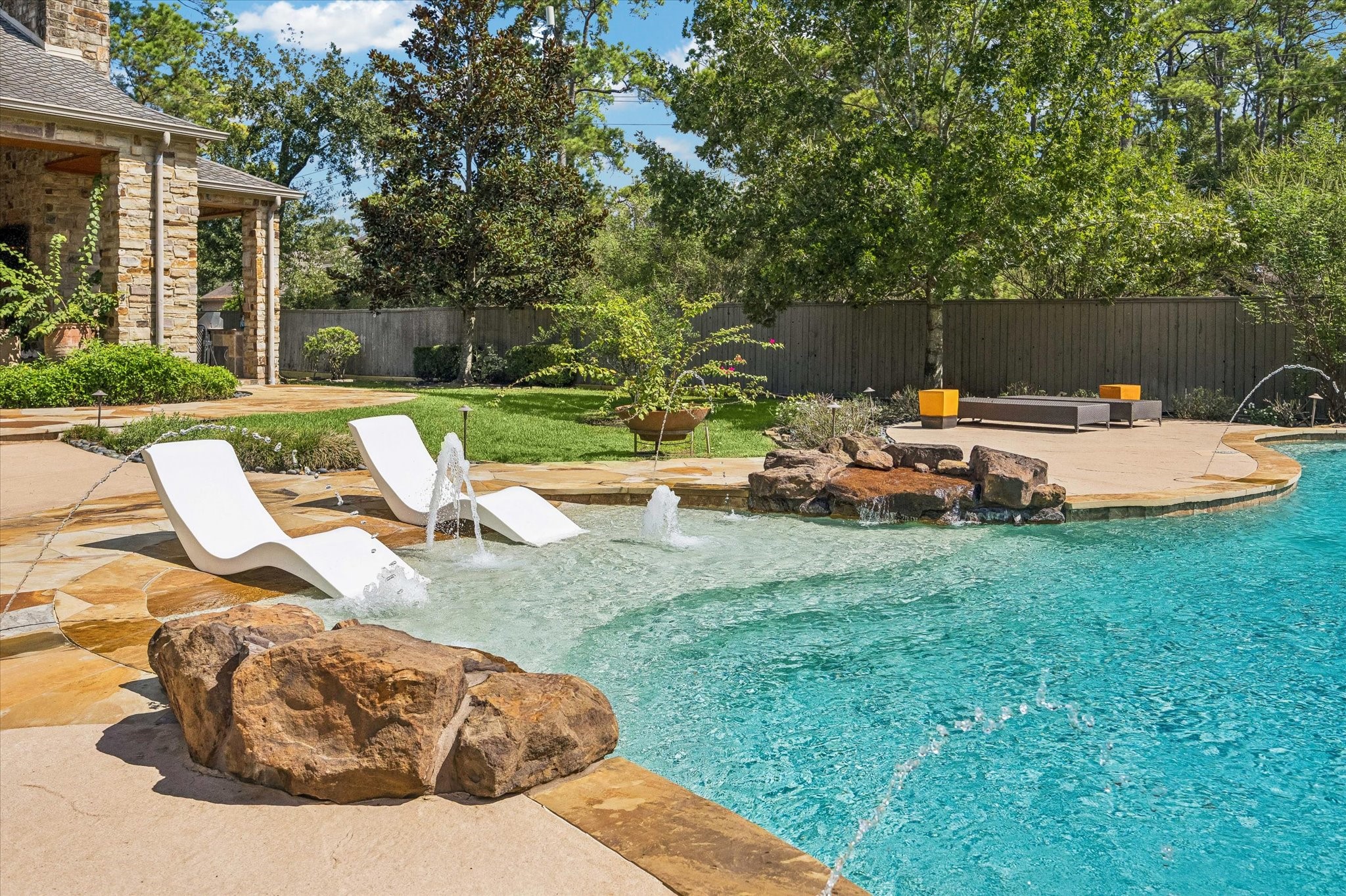 Enjoy the shallow sun shelf and playful water features, creating an inviting spot to relax and cool off on warm summer days.