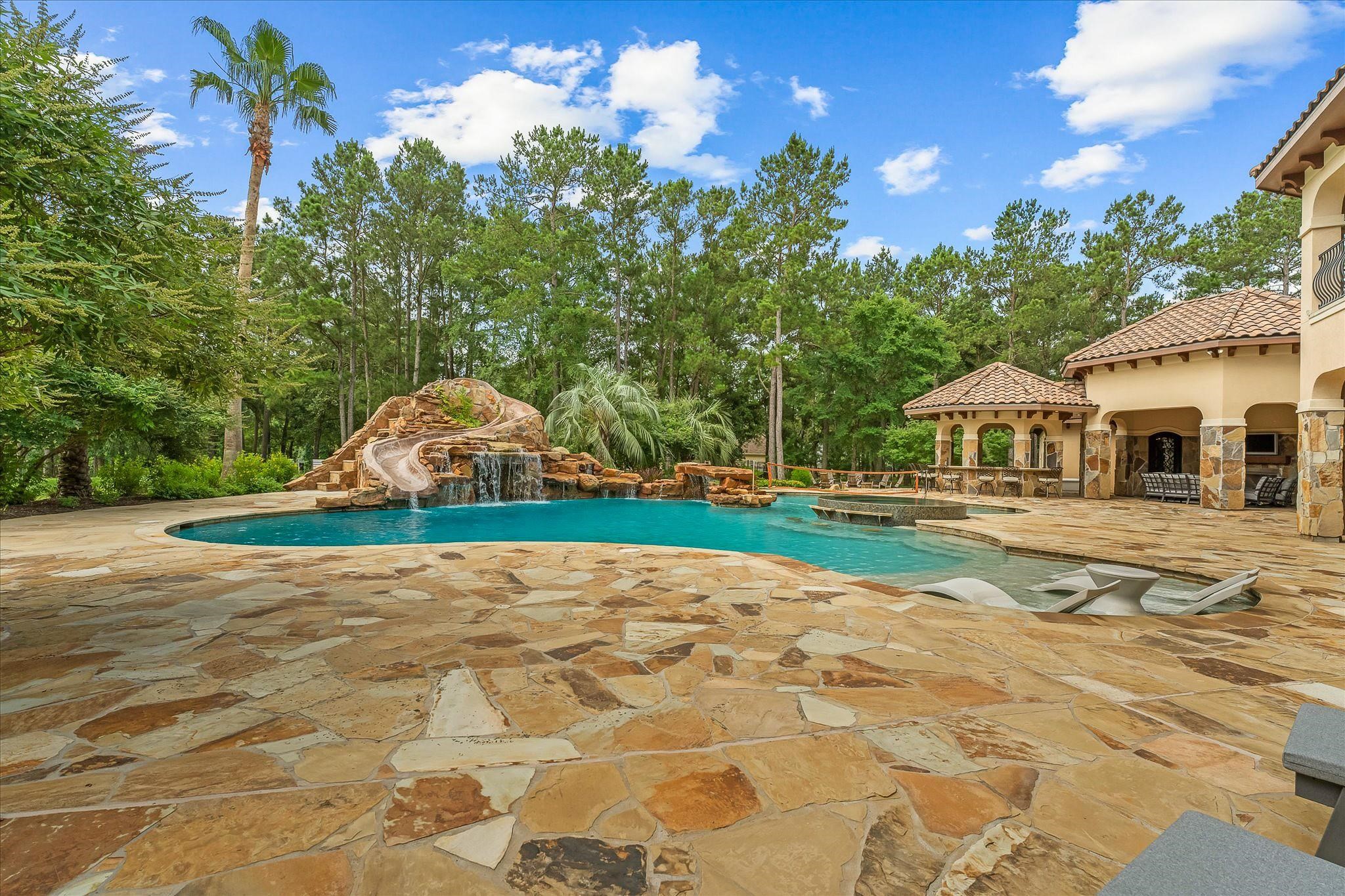 Zero edge spa with swim-up seating and dedicated water sports area.