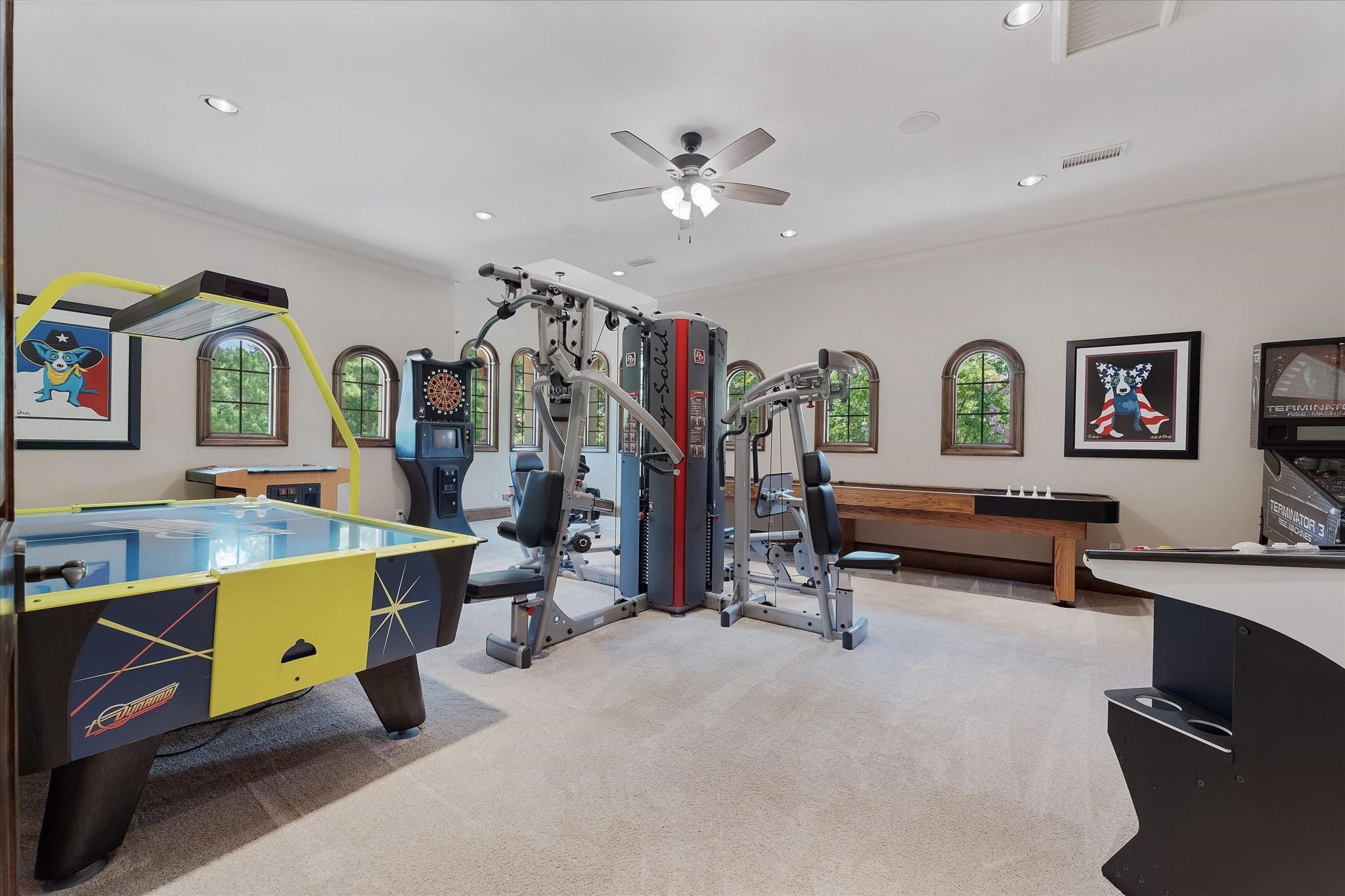 Large game room just off the theater and bar and entertainment space with custom built-ins with cabinets, walk-in closet built-ins.