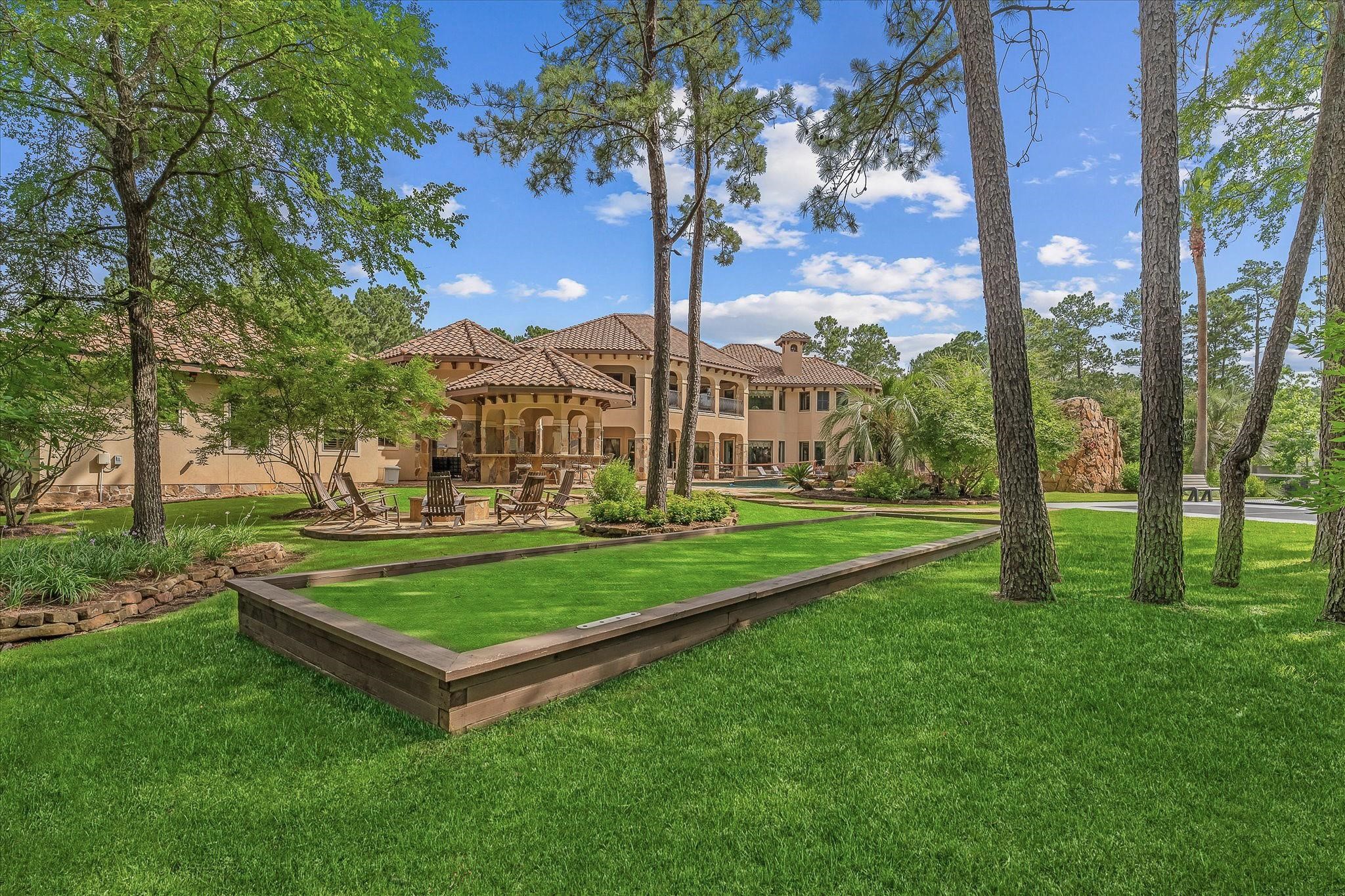 Bocce ball Court next to the wood burning fire pit with seating area surrounding it.