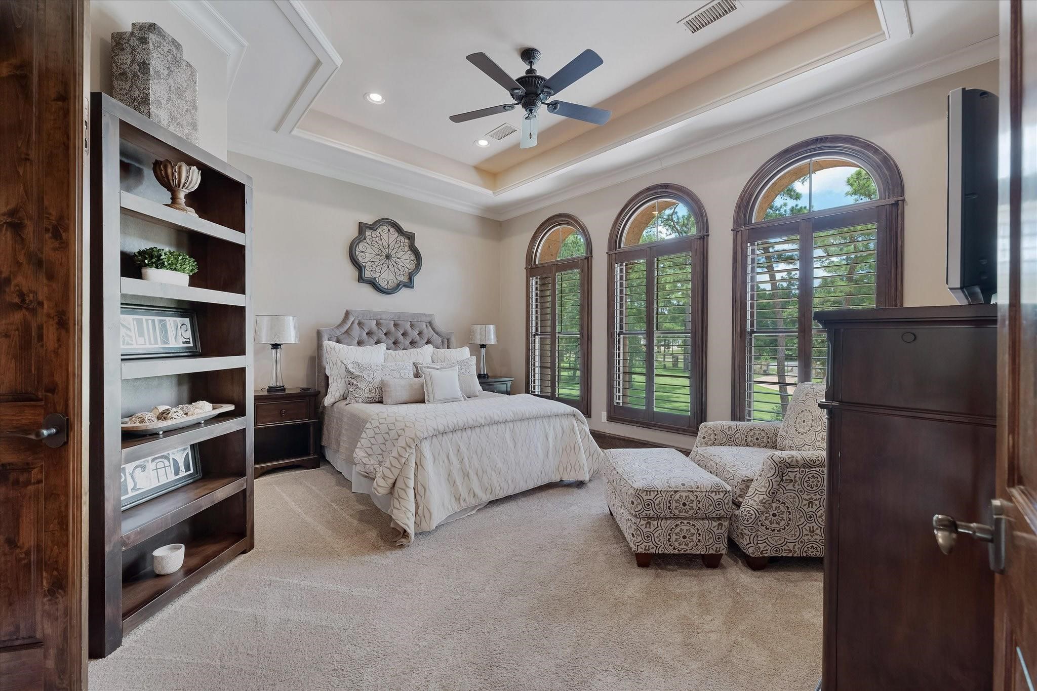 Guest bedroom #1 on the 2nd floor. Dual Mahogany Door Entry and three large arched windows.
