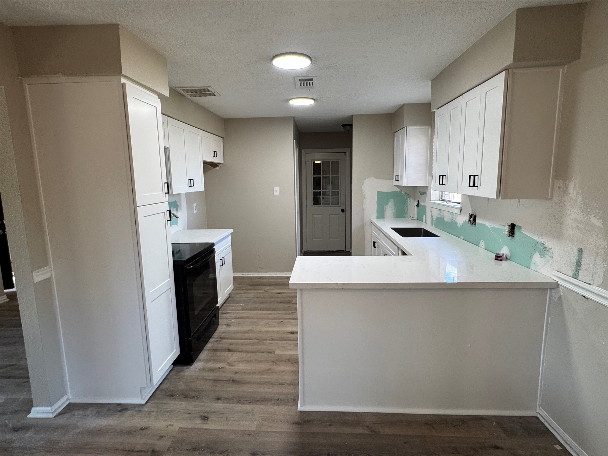 kitchen is being finished.  cabinets and counters installed
