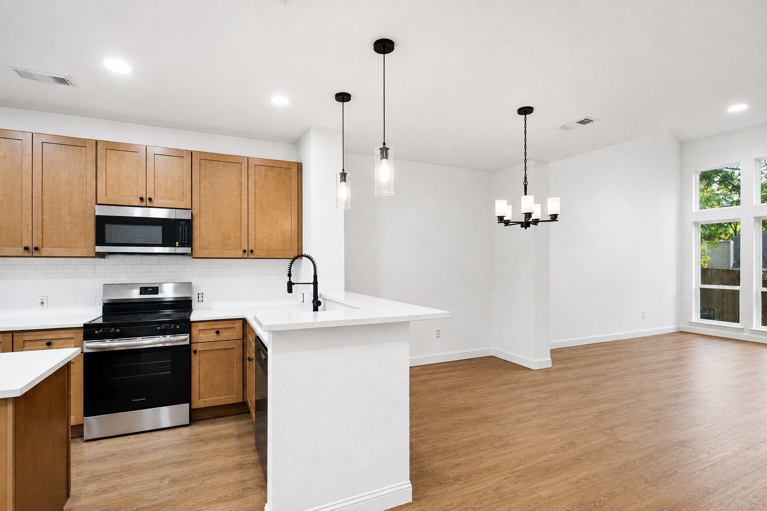 The kitchen features abundant cabinetry, generous counter space and a breakfast bar for casual seating.