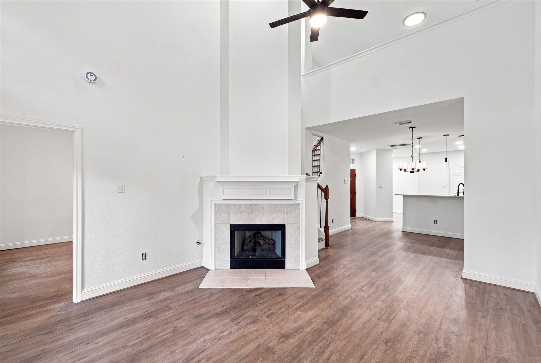 Two-story living room with a fireplace and upstairs overlook.