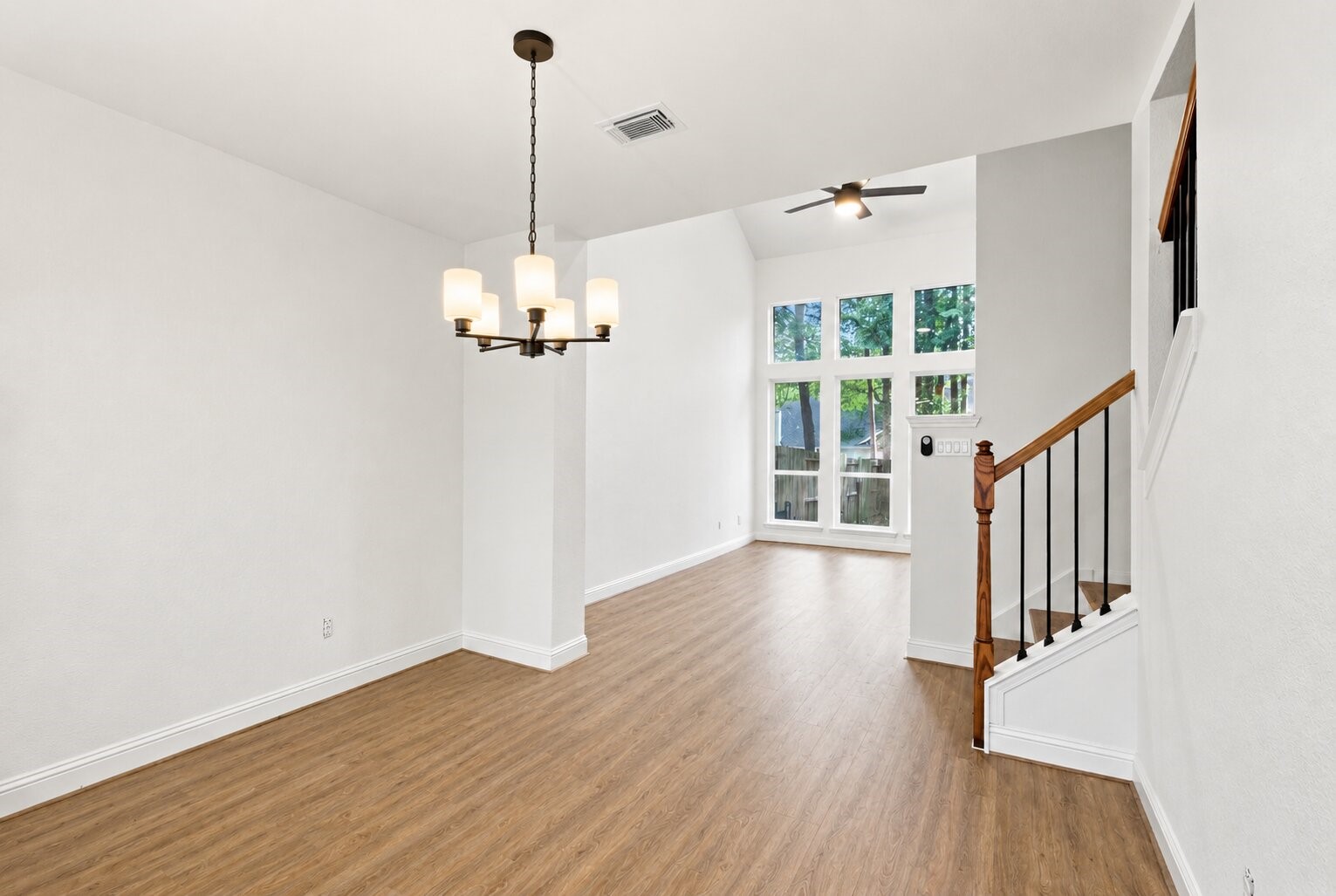 Step inside to an open living and dining area with high ceilings, wood-look flooring and plenty of natural light.