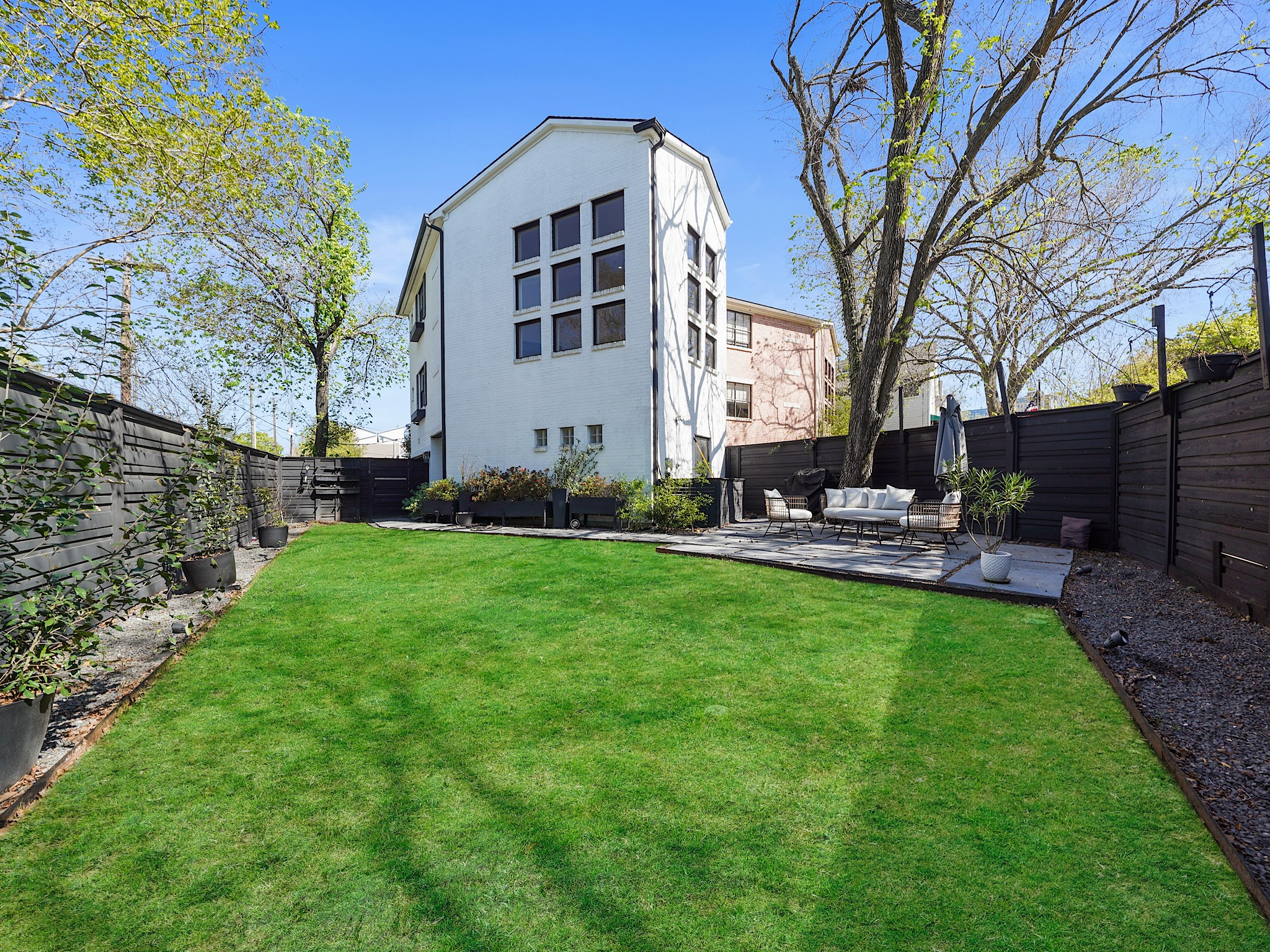 Experience serenity in this beautifully maintained yard, featuring lush green grass perfect for relaxation and outdoor gatherings.