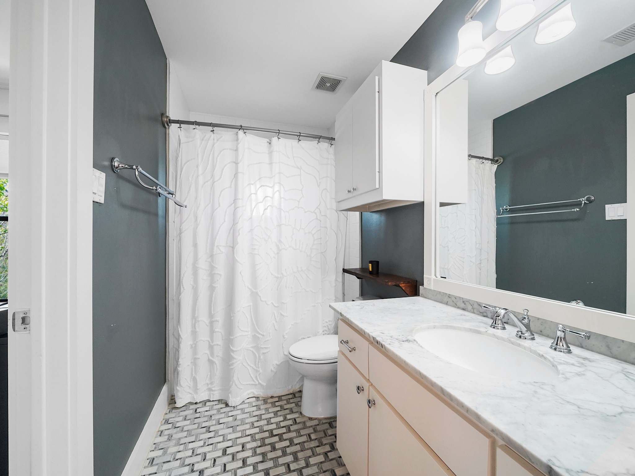 This bright and functional full bath offers a welcoming space ideal for family or guests.