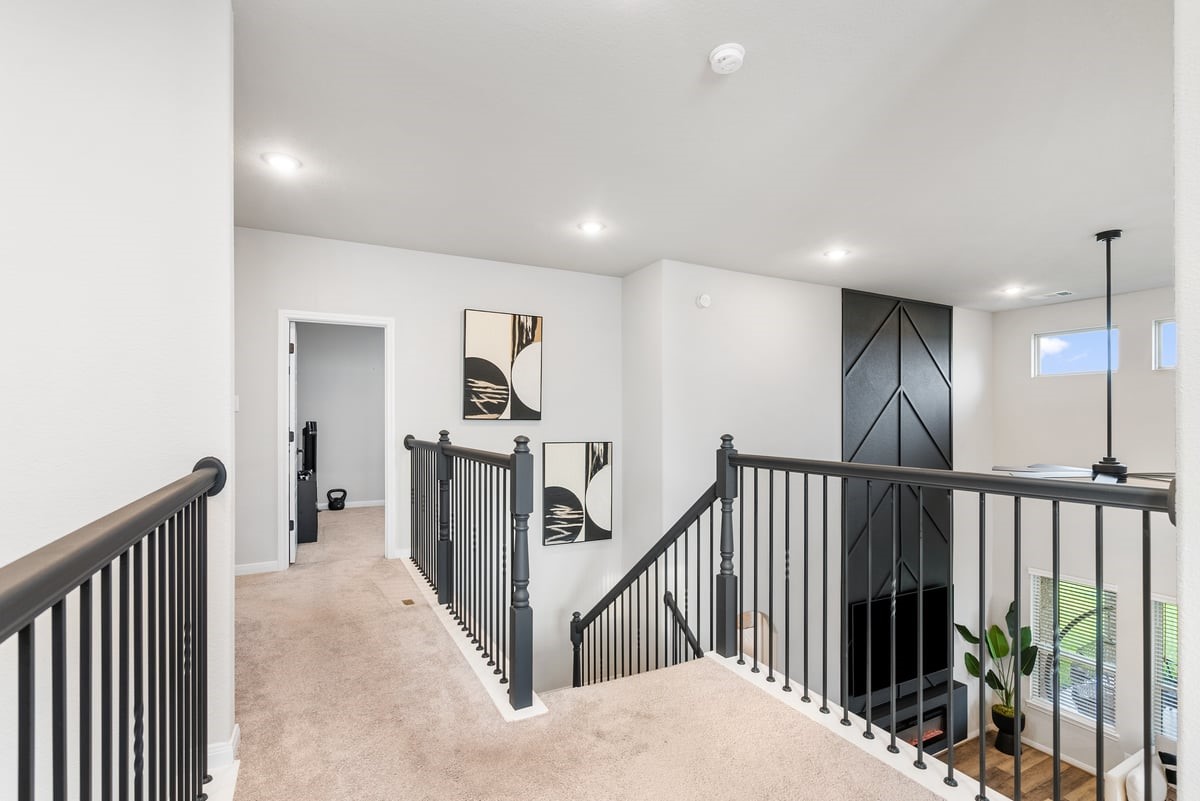 Black rod iron railing lead you to the masterfully designed second floor!