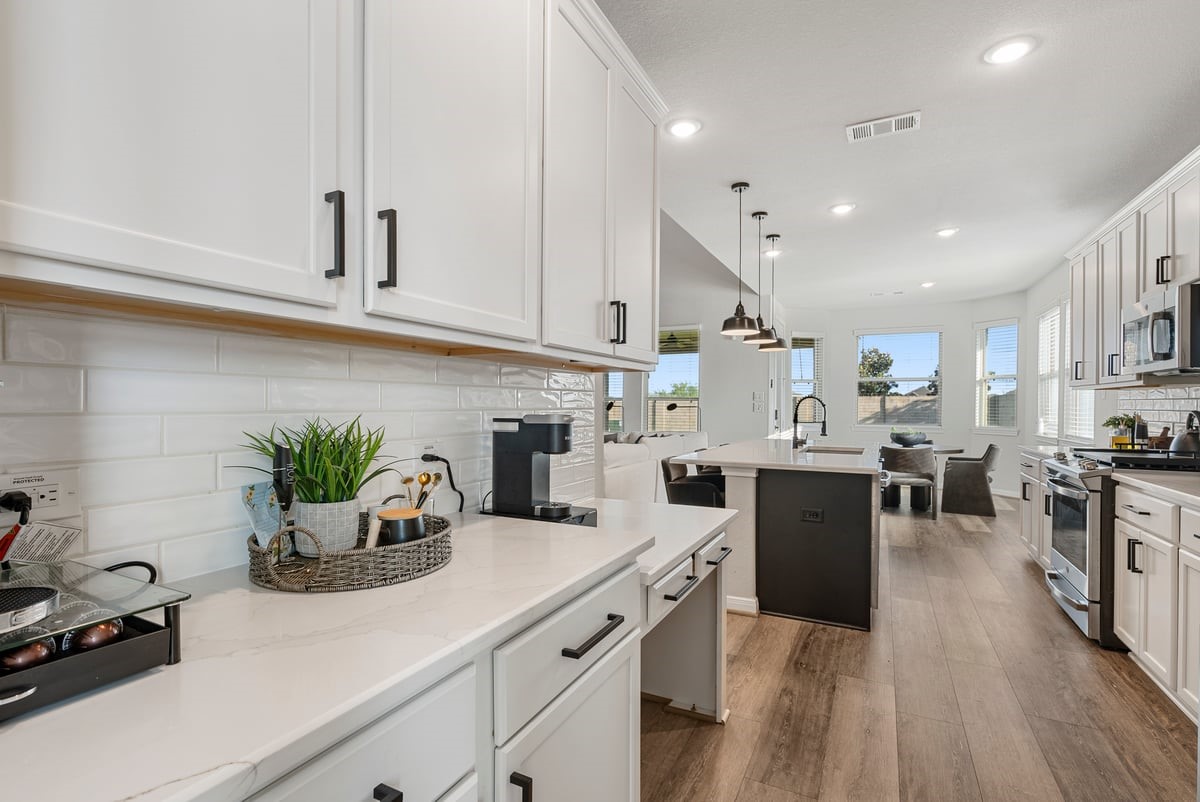 The kitchen has a masterful design with an additional pantry area and built in desk!