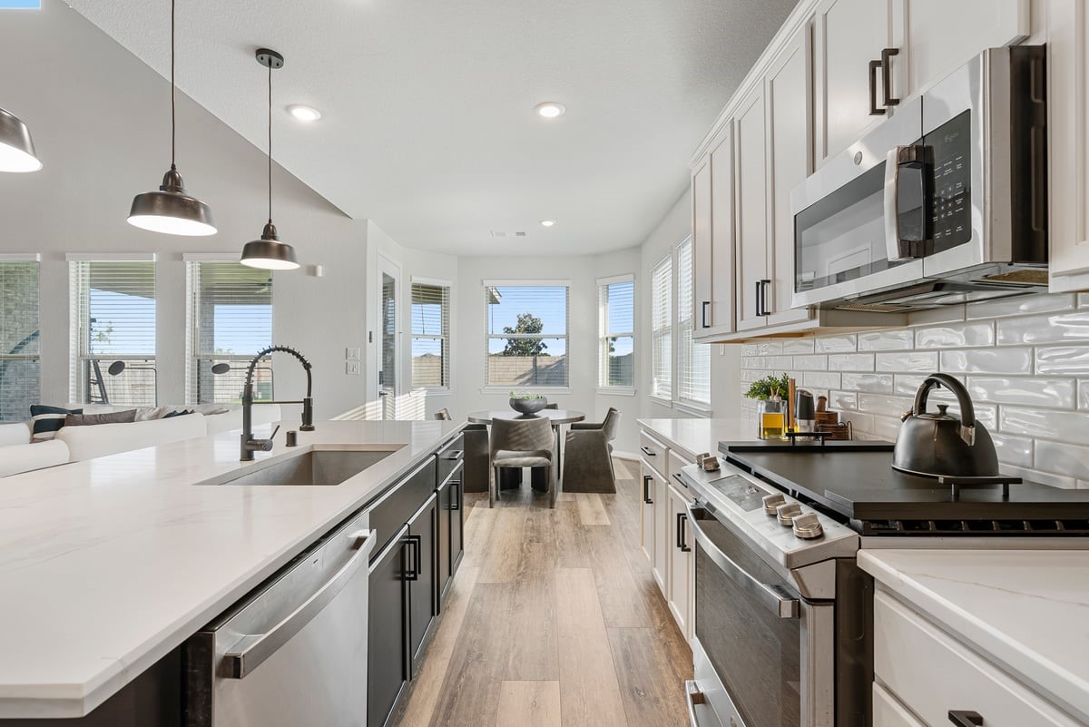 The kitchen feels endless with upgraded quartz counters, two-toned cabinetry and stainless steel appliances! The kitchen feels endless with upgraded quartz counters, two-toned cabinetry and stainless steel appliances!
