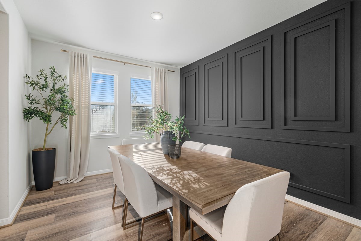 Dine in style! This dining room creates the perfect setting for meals with natural light and stunning accent wall!