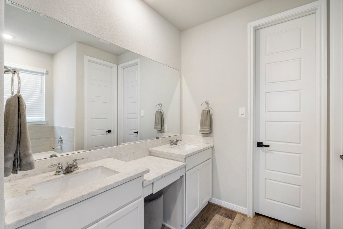 Double sinks and extended vanity provide great storage space for all your personal items!