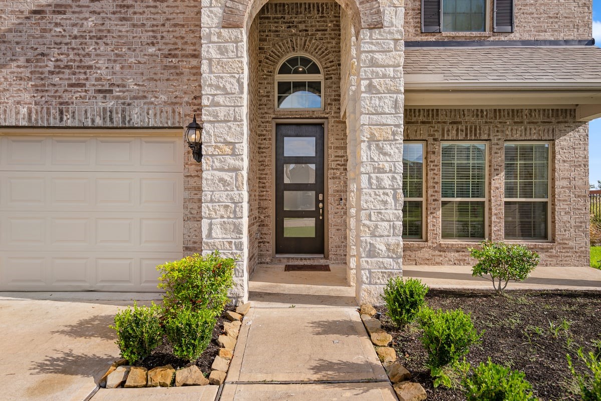 The modern design starts from the front of the home with an oversized glass door!