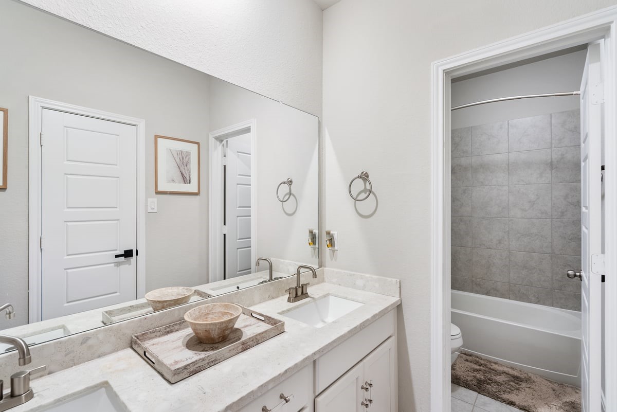 A full bath upstairs echoes the elegance of the other bathrooms! Enjoy plenty of storage space and a private showering area!