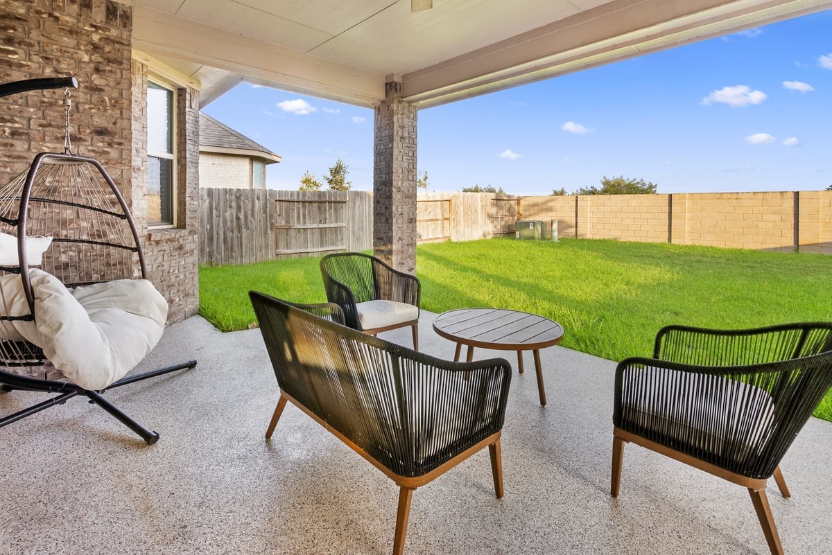 The extended patio has a cover, and is upgraded with epoxy flooring providing a great relaxing space.