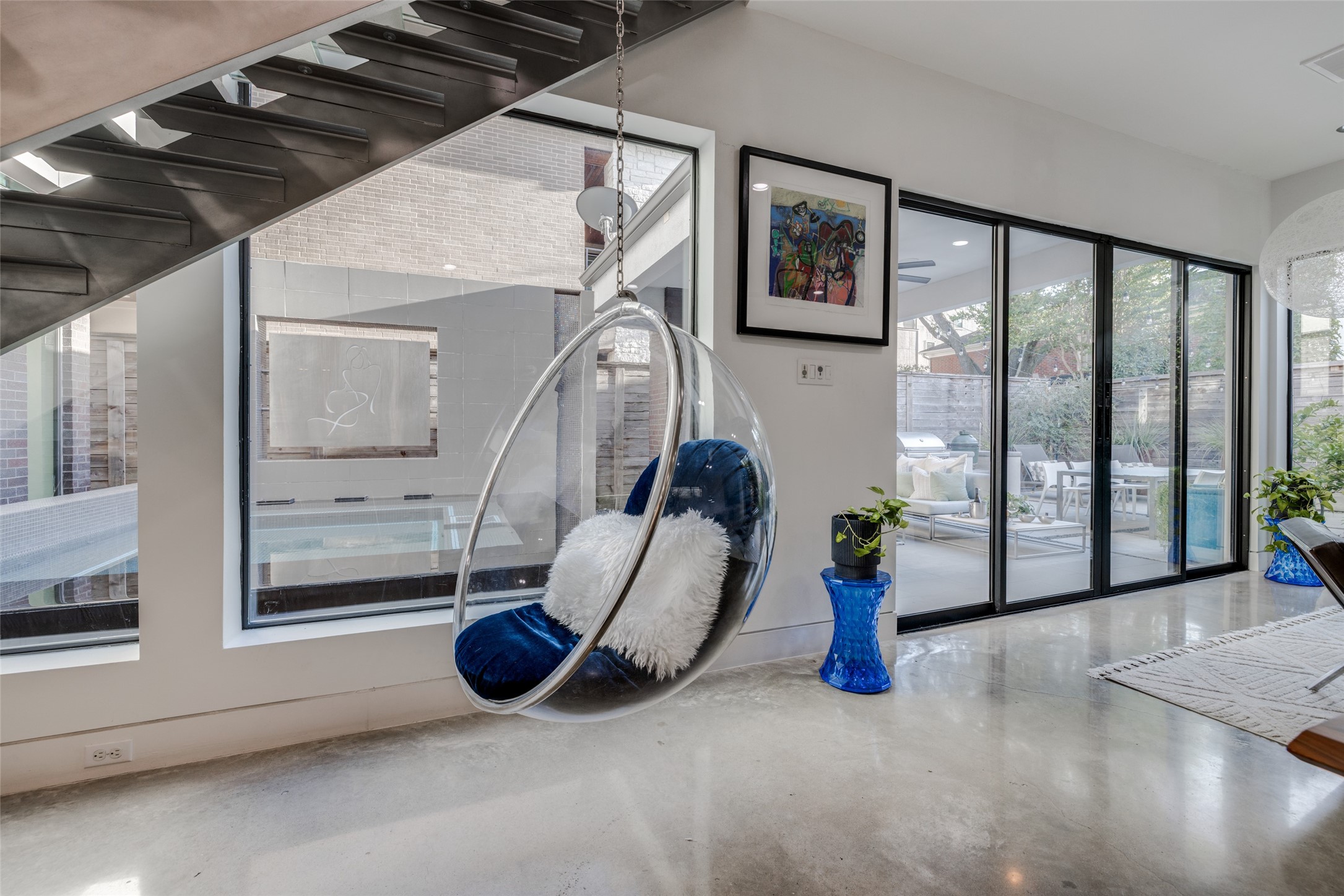 Have fun, relax  & a swing while reading in the under stairs chair - great 360 views of outdoors, pool & inside.