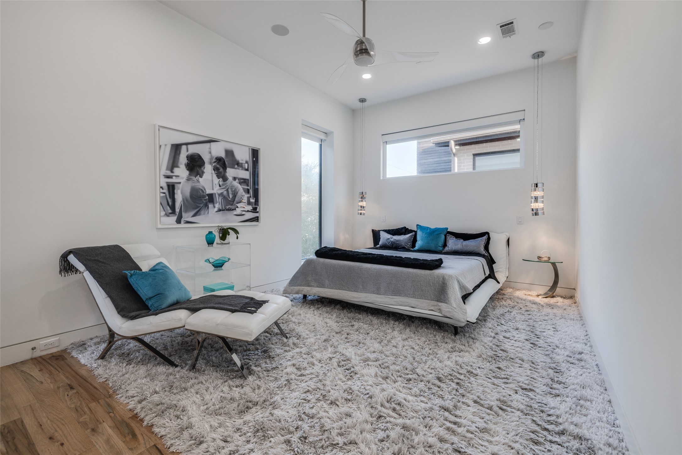 Primary Bedroom with designer carpet & wood flooring, custom motorized  blackout shades, dual designer pendant bedside lights, fan, recessed LED lighting, sitting area & access to balcony & coffee bar, lots of closets & storage, in ceiling speakers