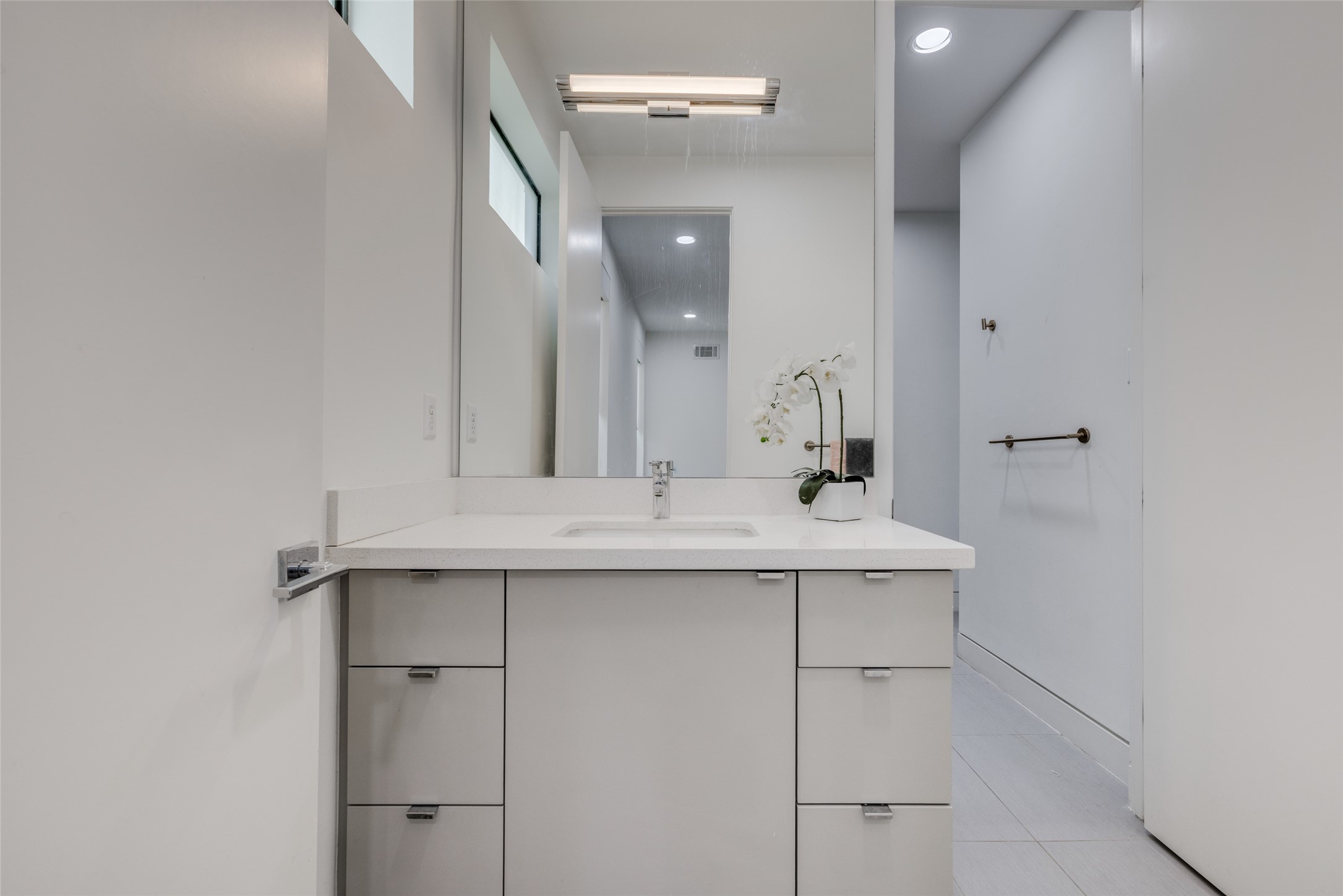 Jack & Jill Bathroom, private vanity areas, chrome Hansgrohe faucets, custom designer mirrors, pro flo commode, open shelving, neutral designer paint throughout
