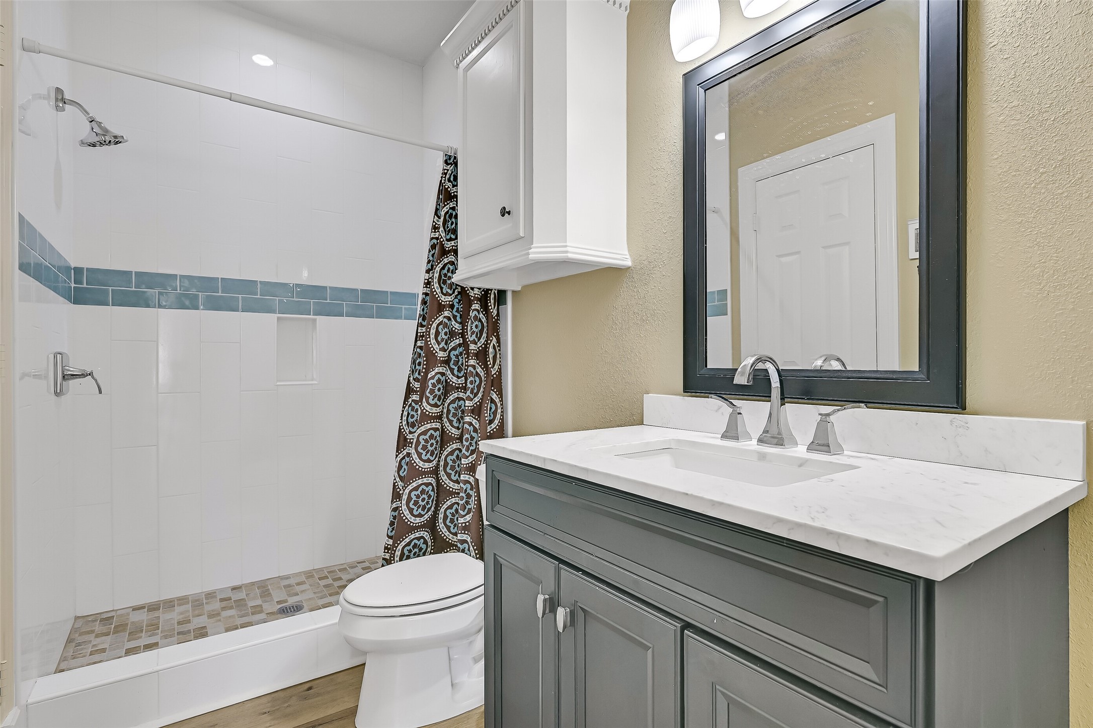 The shared guest bathroom with large shower.